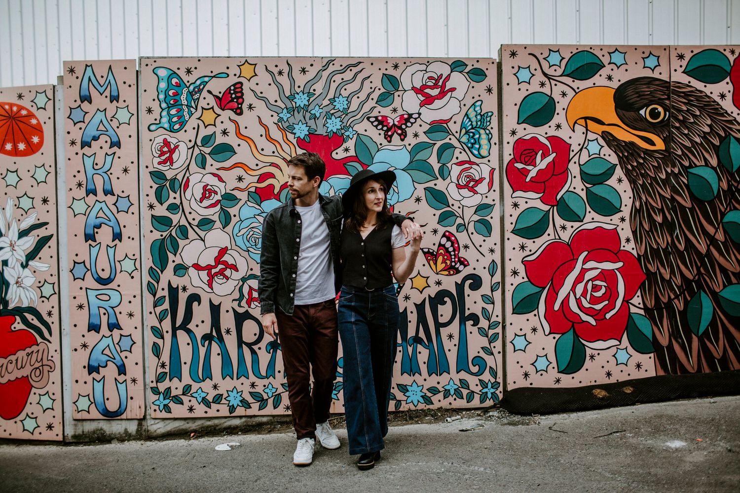 Couple walking away from camera holding hands