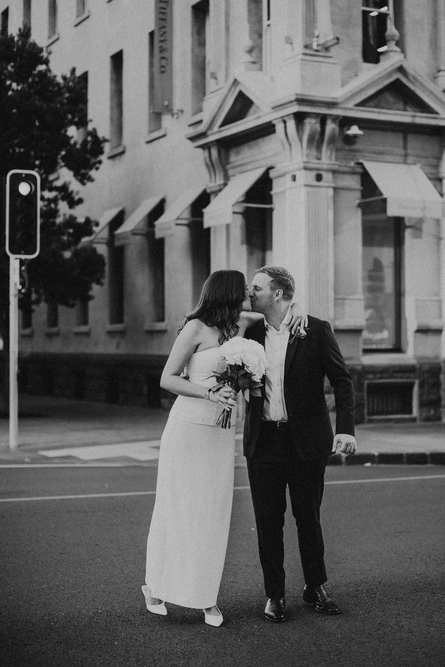Couple embracing with eyes closed during golden hour session