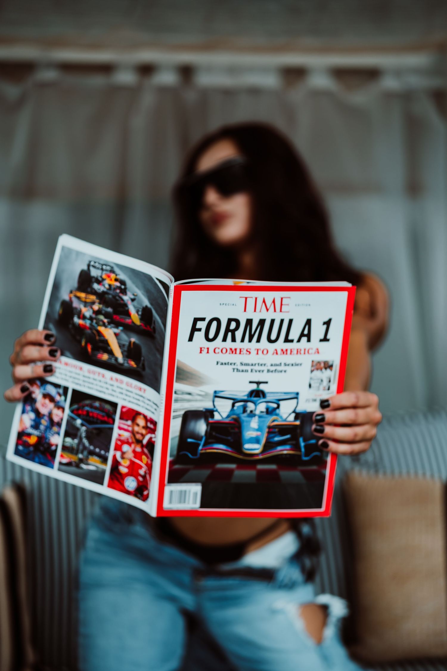 Woman in sunglasses reading a TIME Magazine Formula 1 special edition about F1 coming to America.