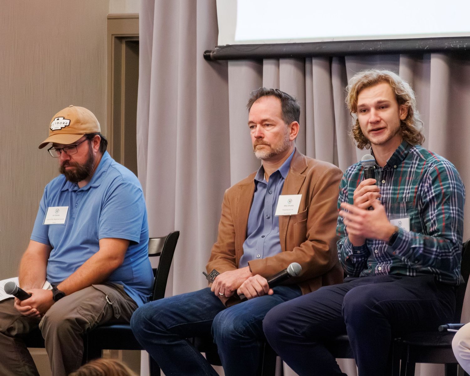 Panel of people talking at a conference