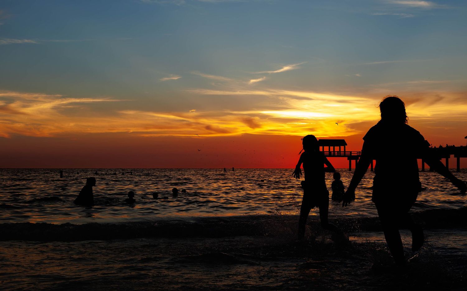 Children running towards clearwater beach water in florida