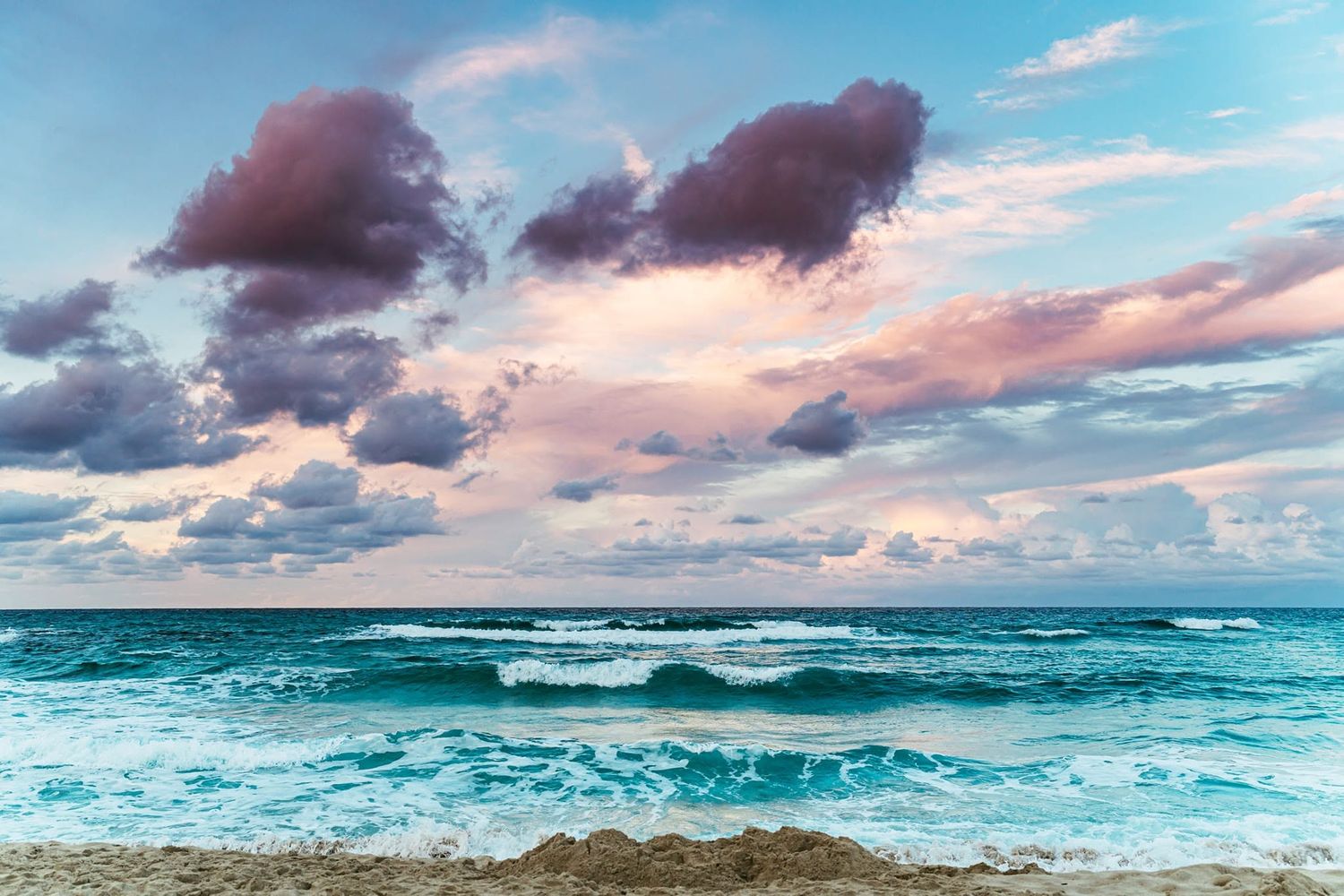 Ocean waves beneath a colourful sunset sky, creating a peacefull coastal landscape with dramatic clouds and evening light.