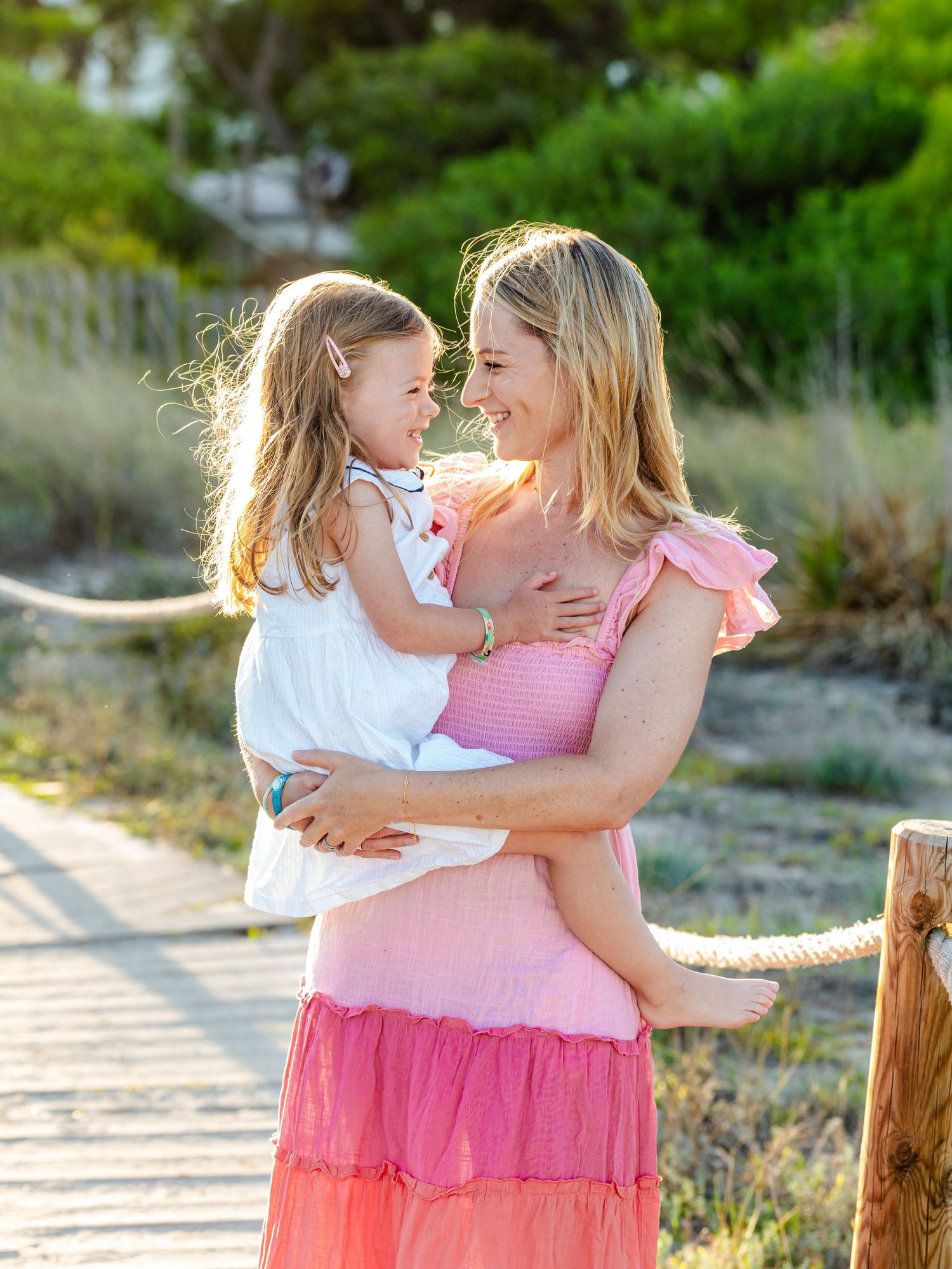 A mother holding her daughter close, where laughter becomes the memory they'll both carry. Family photography by Herzenshaus Studio.