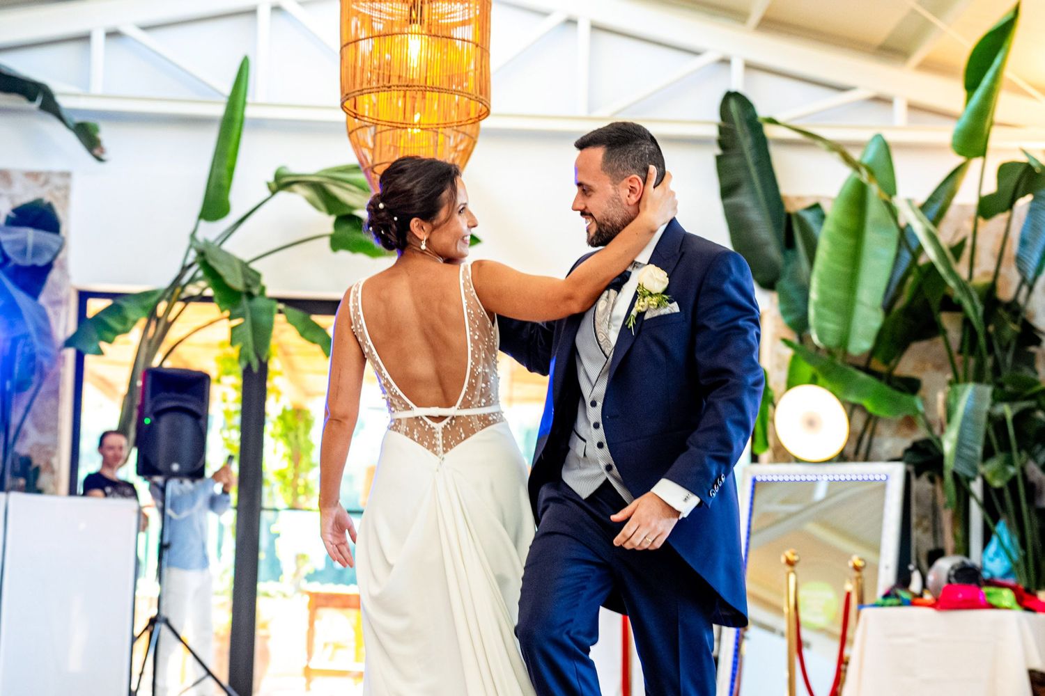 Bride and groom sharing a joyful moment while dancing together during their wedding reception. Wedding photography, Herzenshaus Studio.