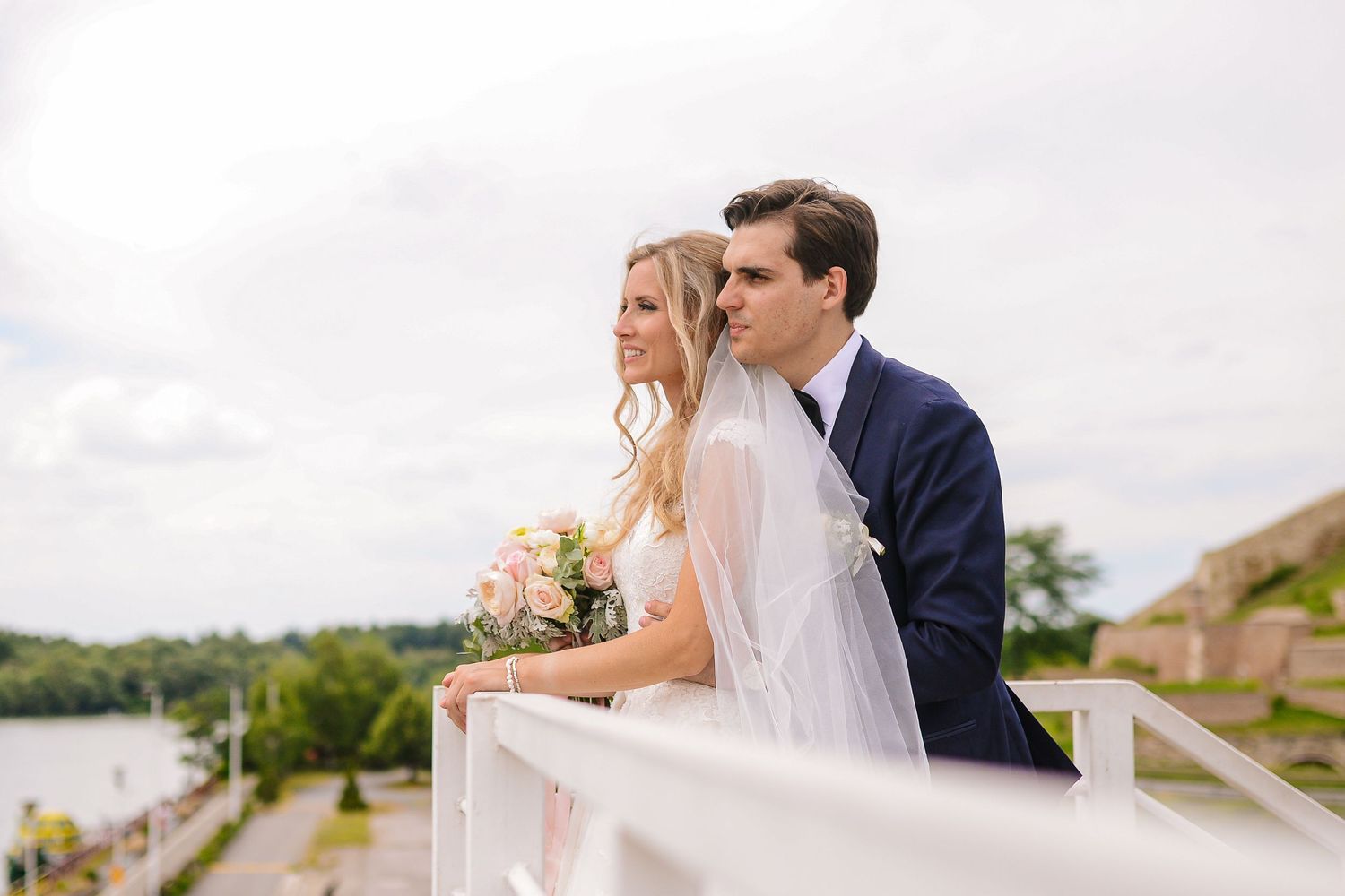 Bride and groom overlooking the water together, a quiet pause within their wedding day by Herzenshaus Studio, Frankfurt Rhein-Main.