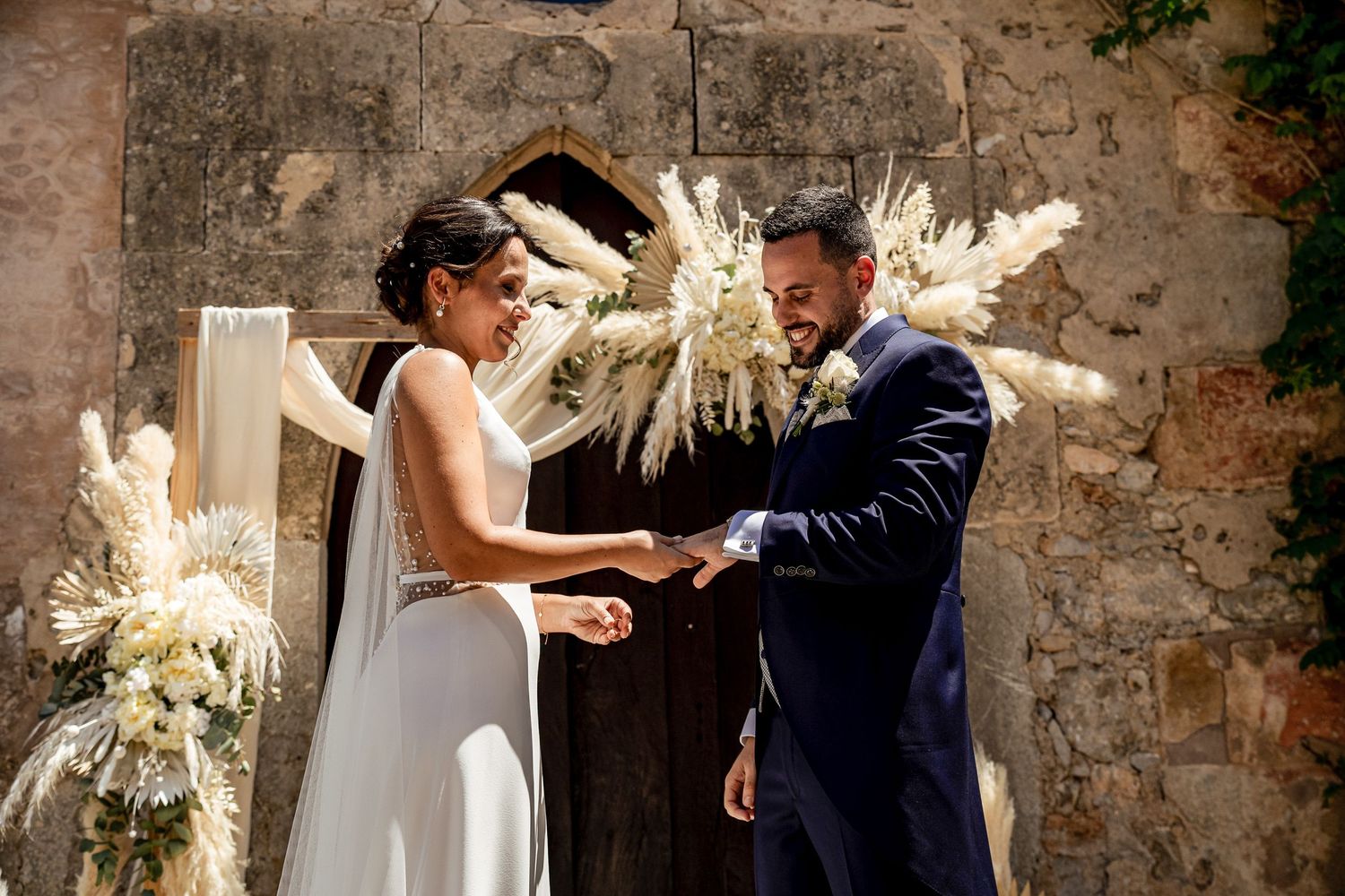 Bride and groom exchanging rings during an intimate wedding ceremony, candid documentary wedding photography
