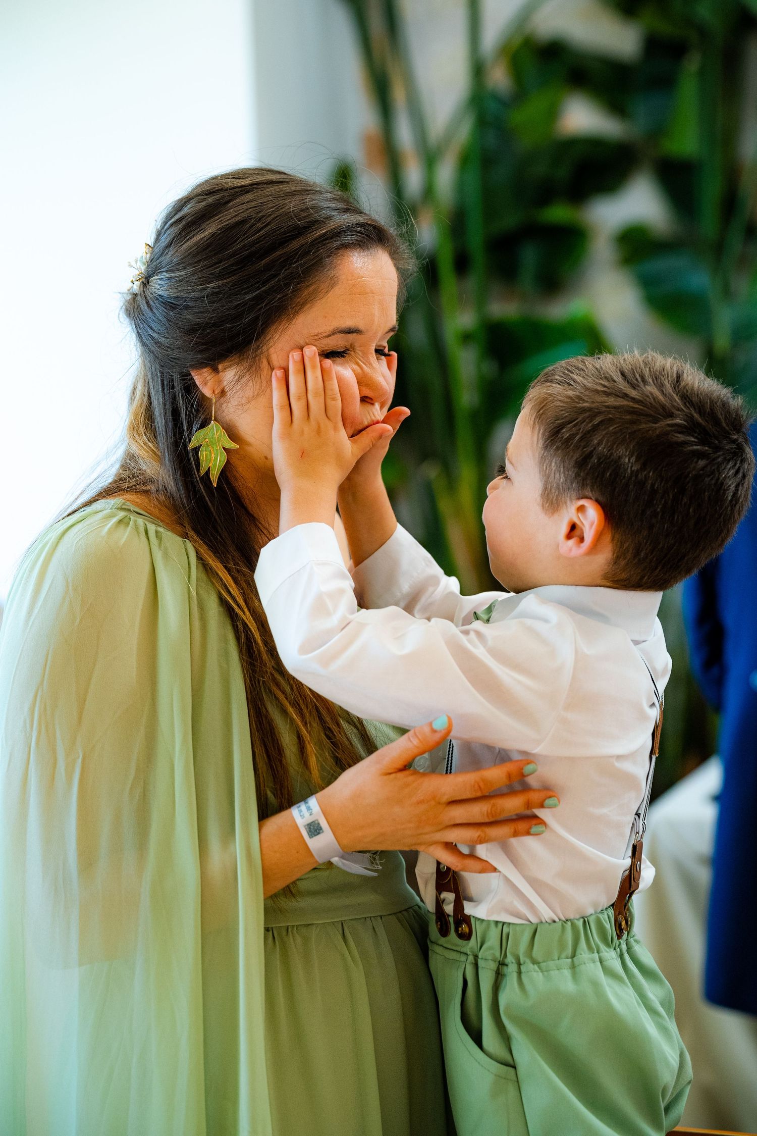 A child gently holding his mother's face, capturing the tenderness and trust at the heart of family photography, by Herzenshaus Studio.