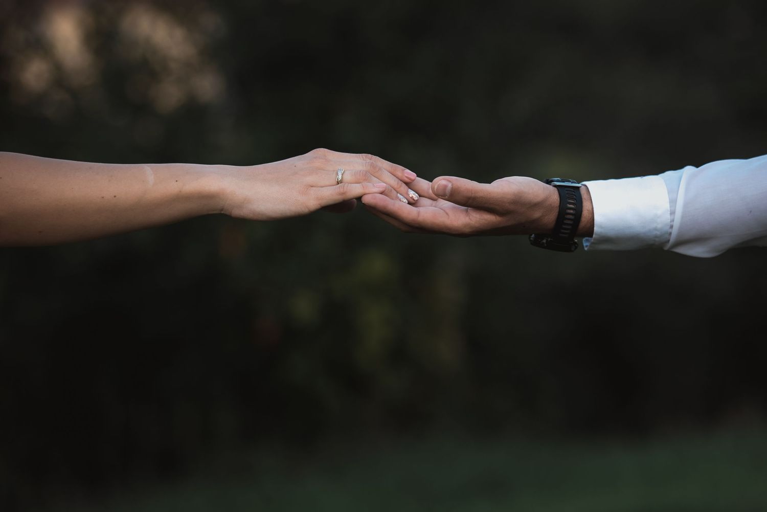 Two hands meeting in a quiet gesture of love and commitment, capturing the promise at the heart of a wedding story, by Herzenshaus Studio.