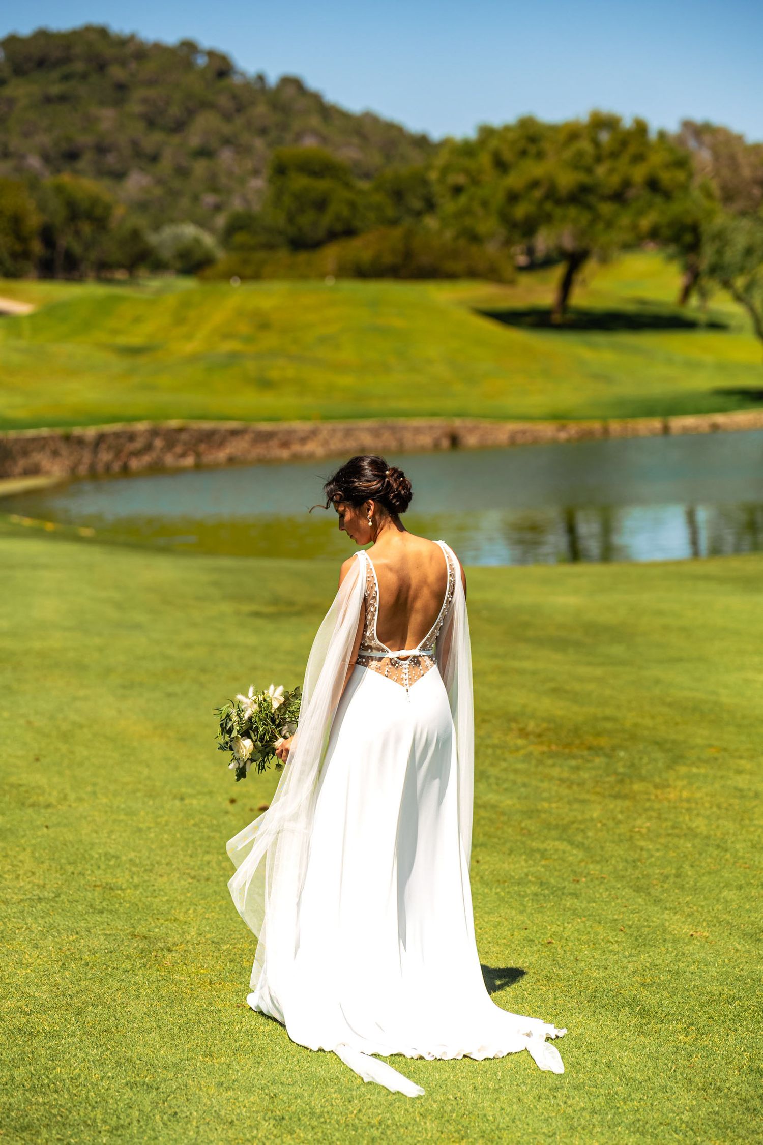 Bride standing quietly in the landscape, a moment of stillness before everything changes - wedding photography by Herzenshaus Studio, Frankf