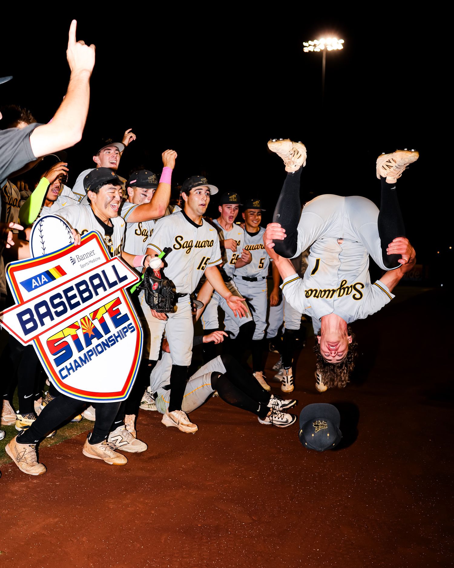 Saguaro baseball team celebrates AIA Baseball State Championship win with player doing backflip.