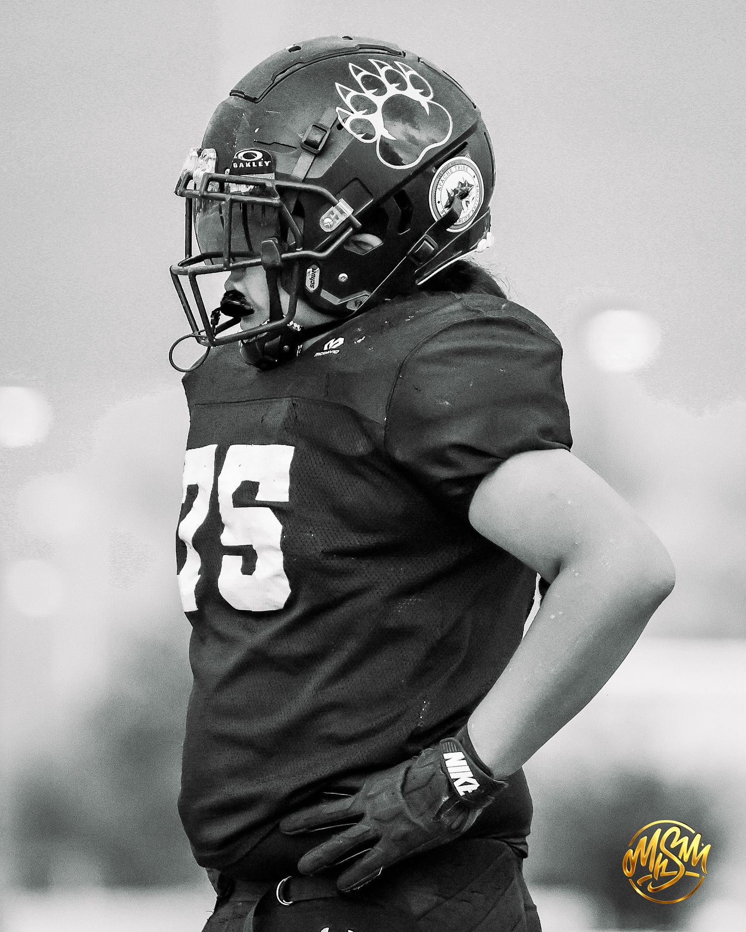 Black and white portrait of a youth football player wearing number 35 jersey and bear claw helmet.