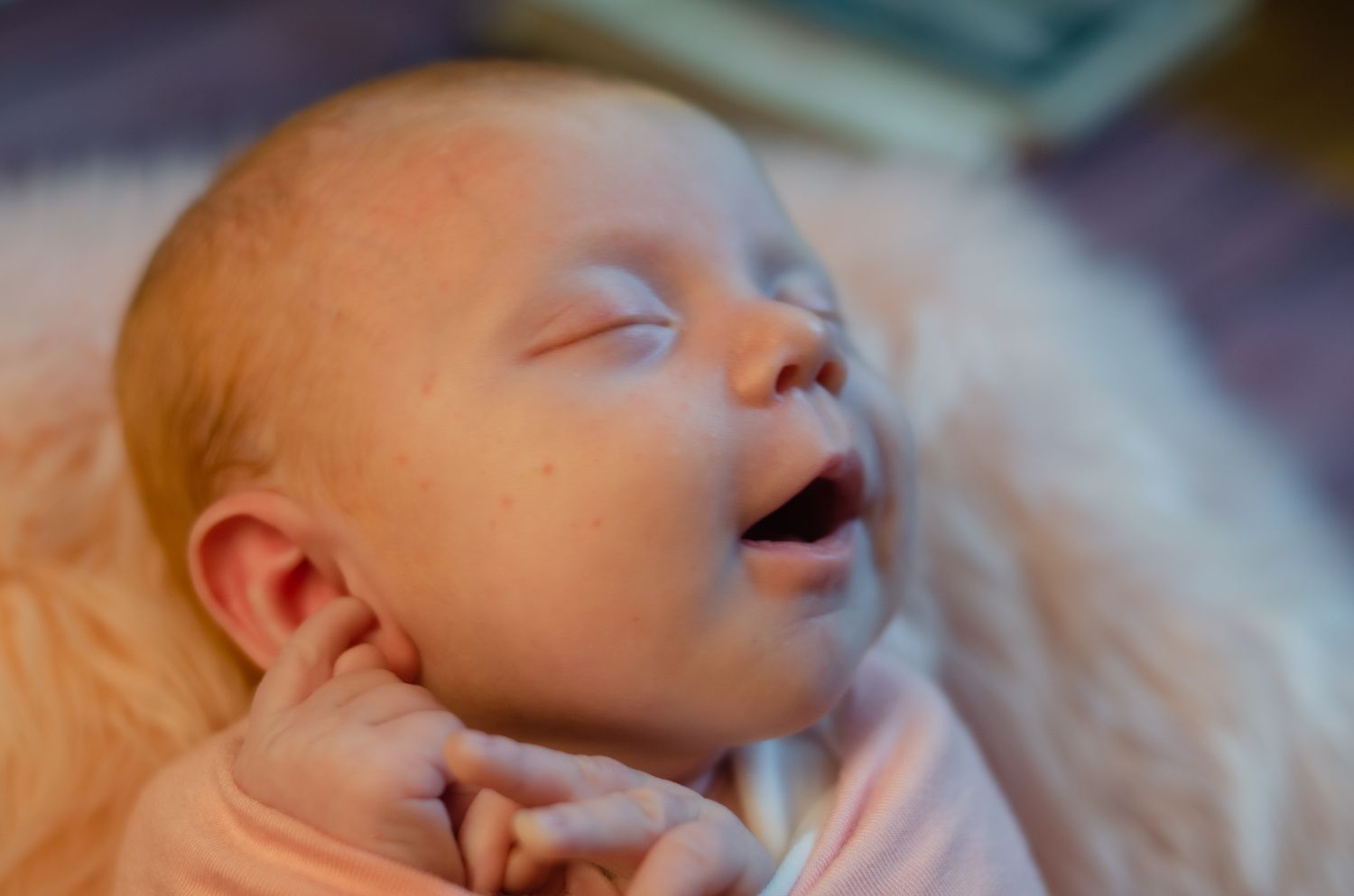 smiling newborn girl on pink fur in Henderson Texas home studio