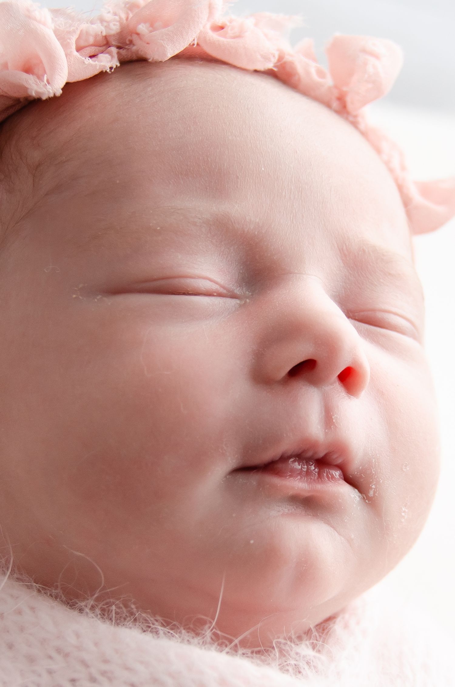 close up micro detail shot of newborn girl in professional photography studio