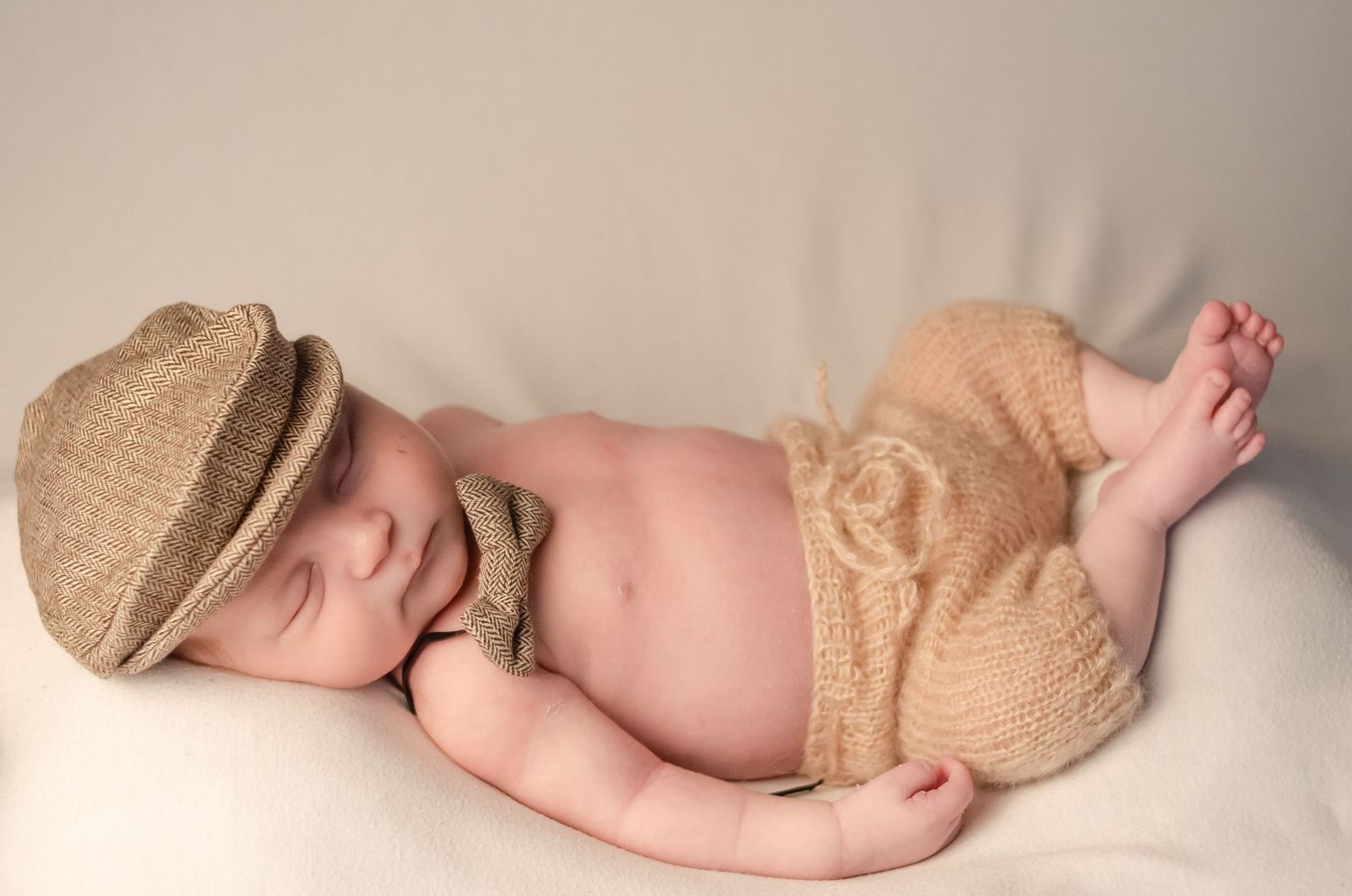 baby boy in prop hat and matching pants in home studio in east texas with professional photographer