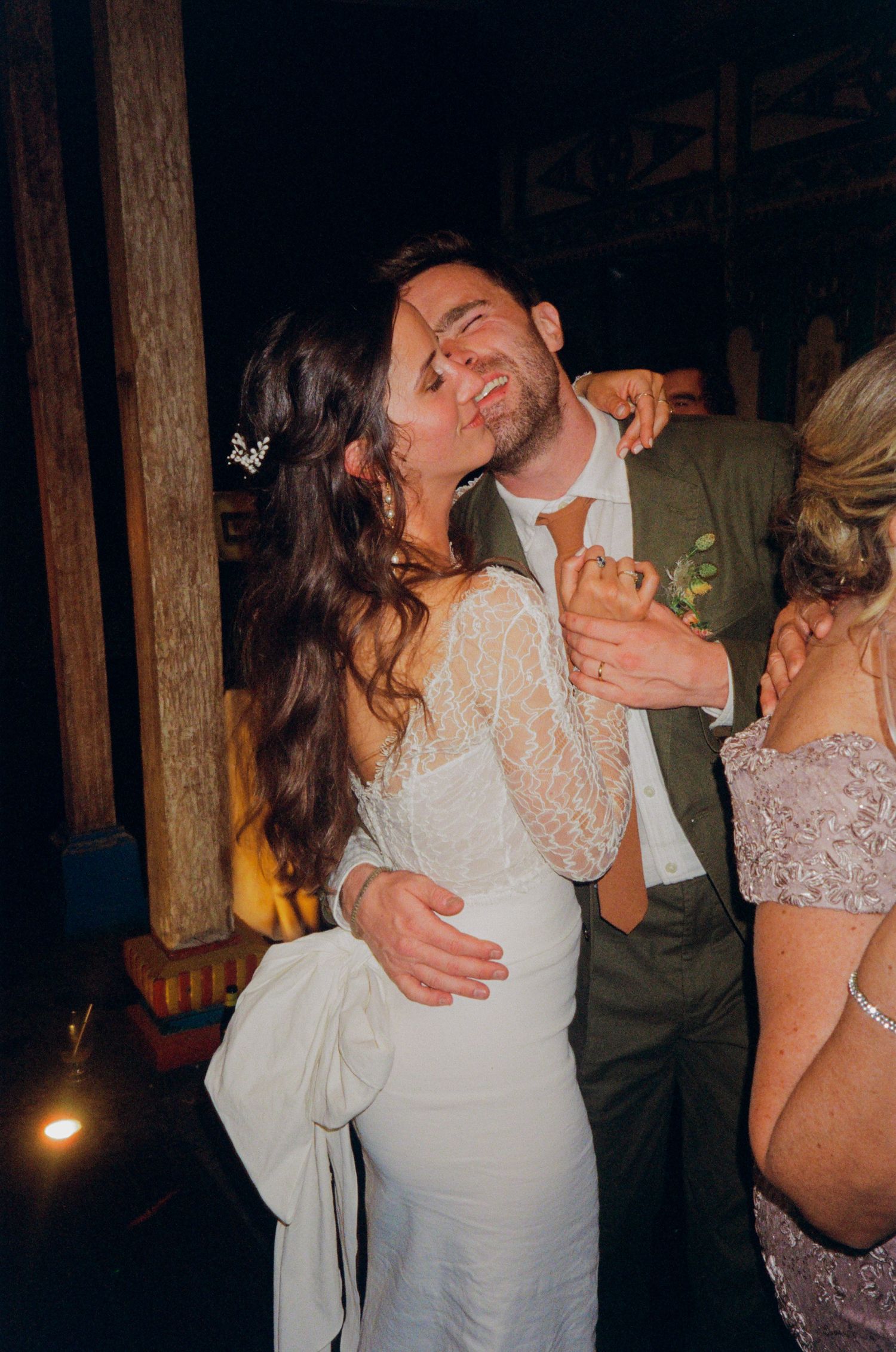 Bride and groom sharing a joyful embrace on the dance floor during their wedding reception.