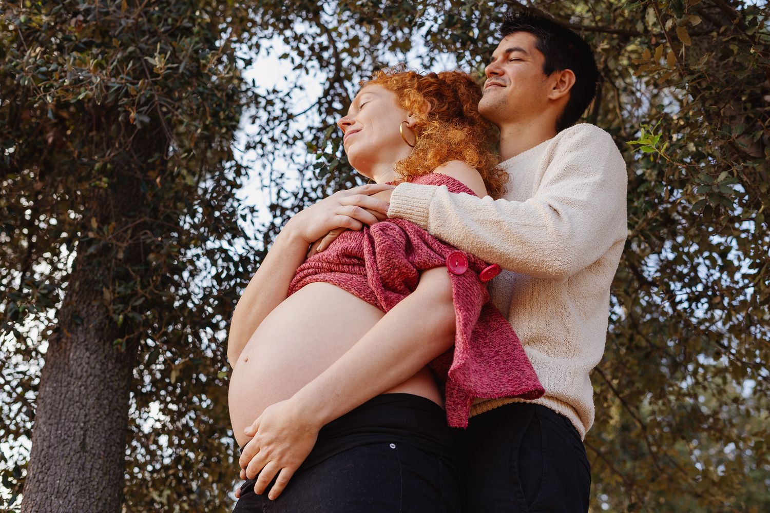 Couple hugging, the woman is pregnant