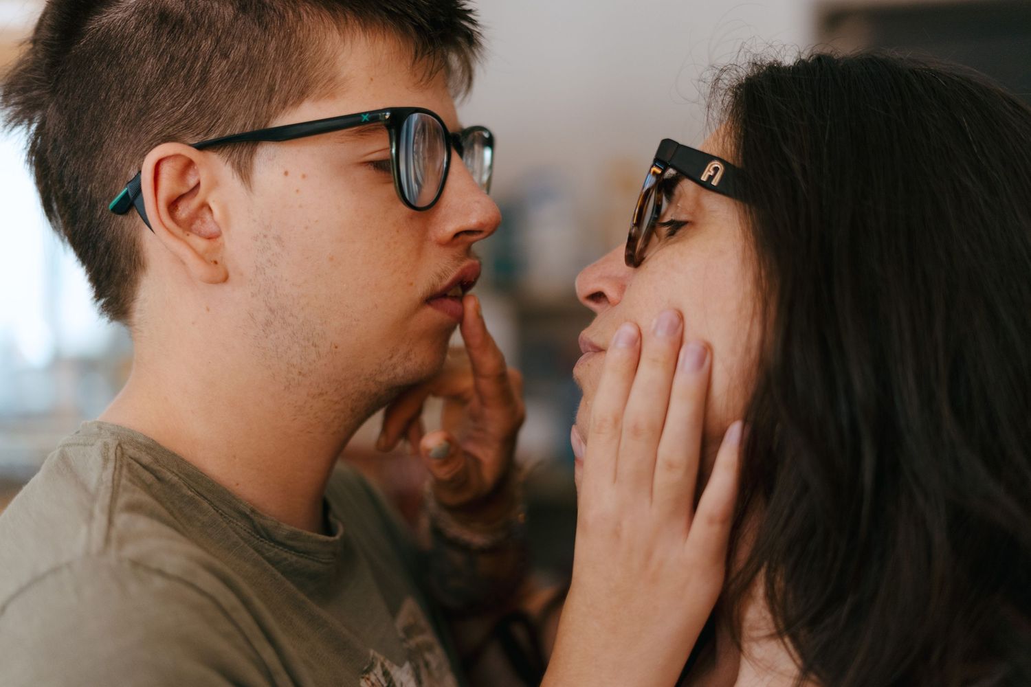 Boy kissing his mother
