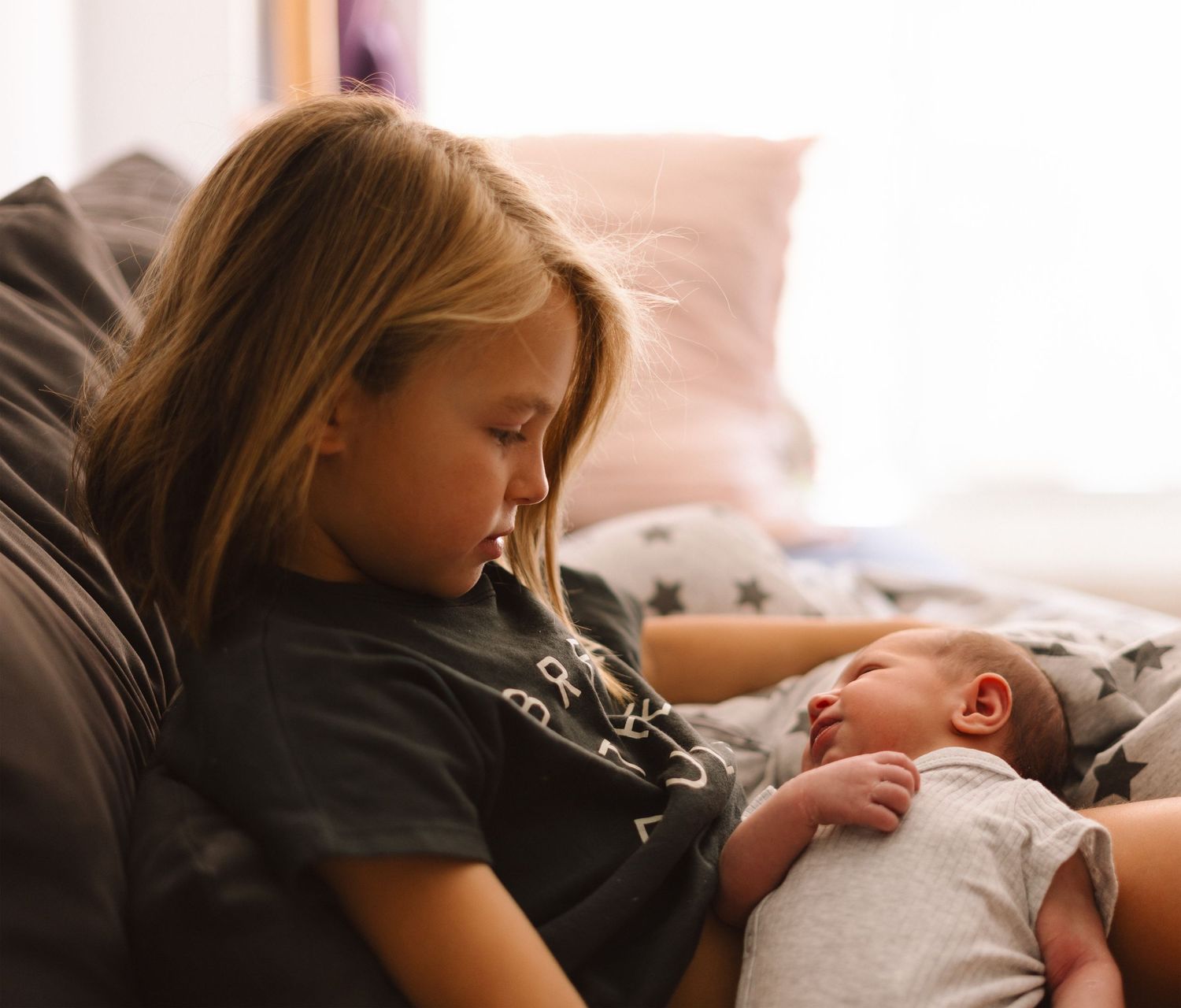 Little girl holding a baby