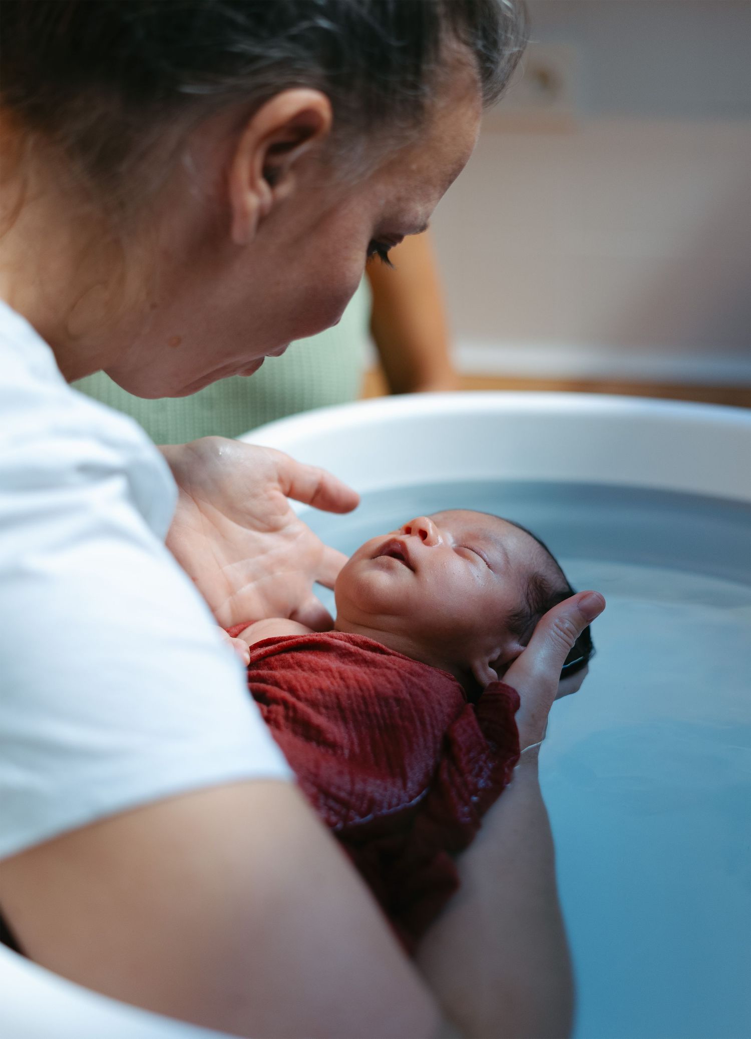 Parents bathing their baby