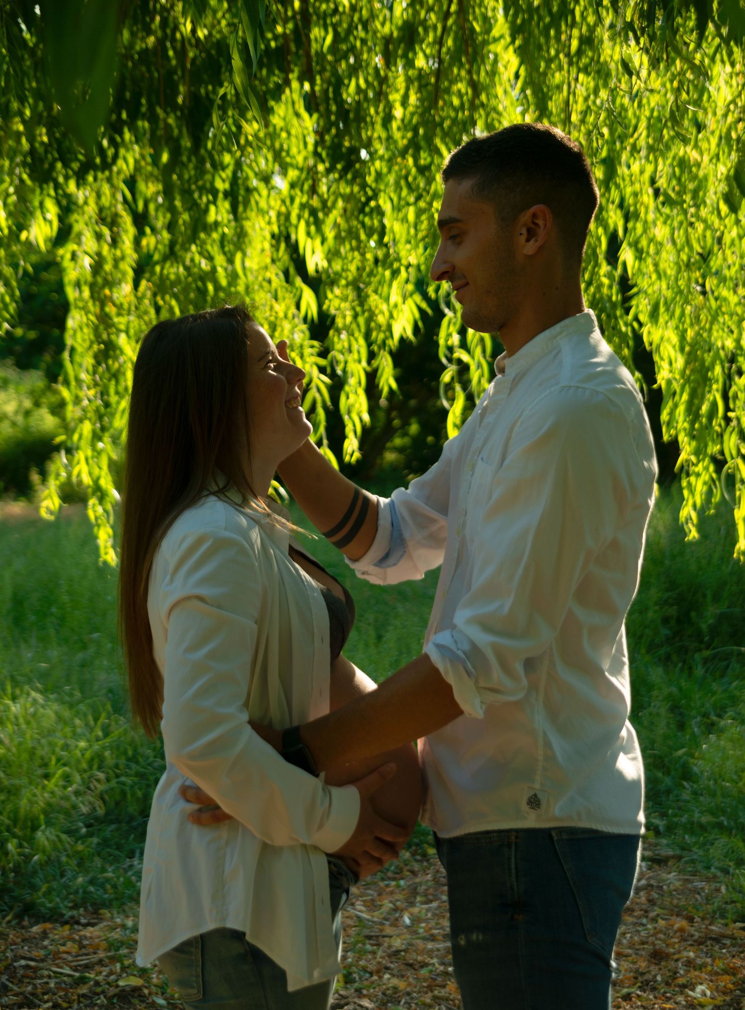 Pregnant woman in the woods with his husband