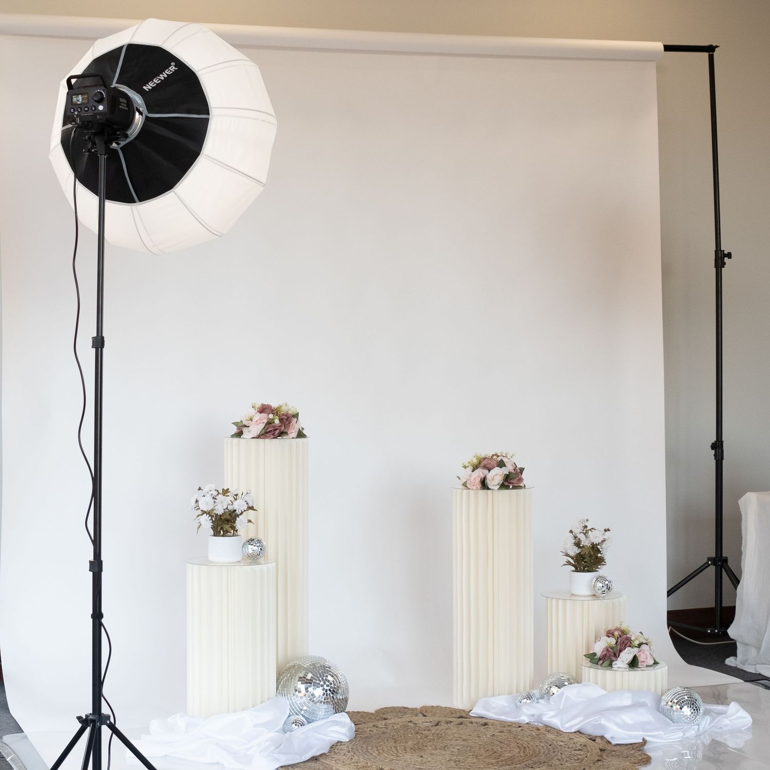 Photo booth studio setup with softbox light, white columns and floral decorations. Perth WA Photo booth Hire Event Booth