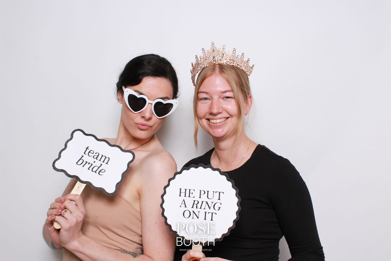 Two people having fun with photo booth props including a crown and wedding signs. Perth WA Photo booth Hire Event Booth
