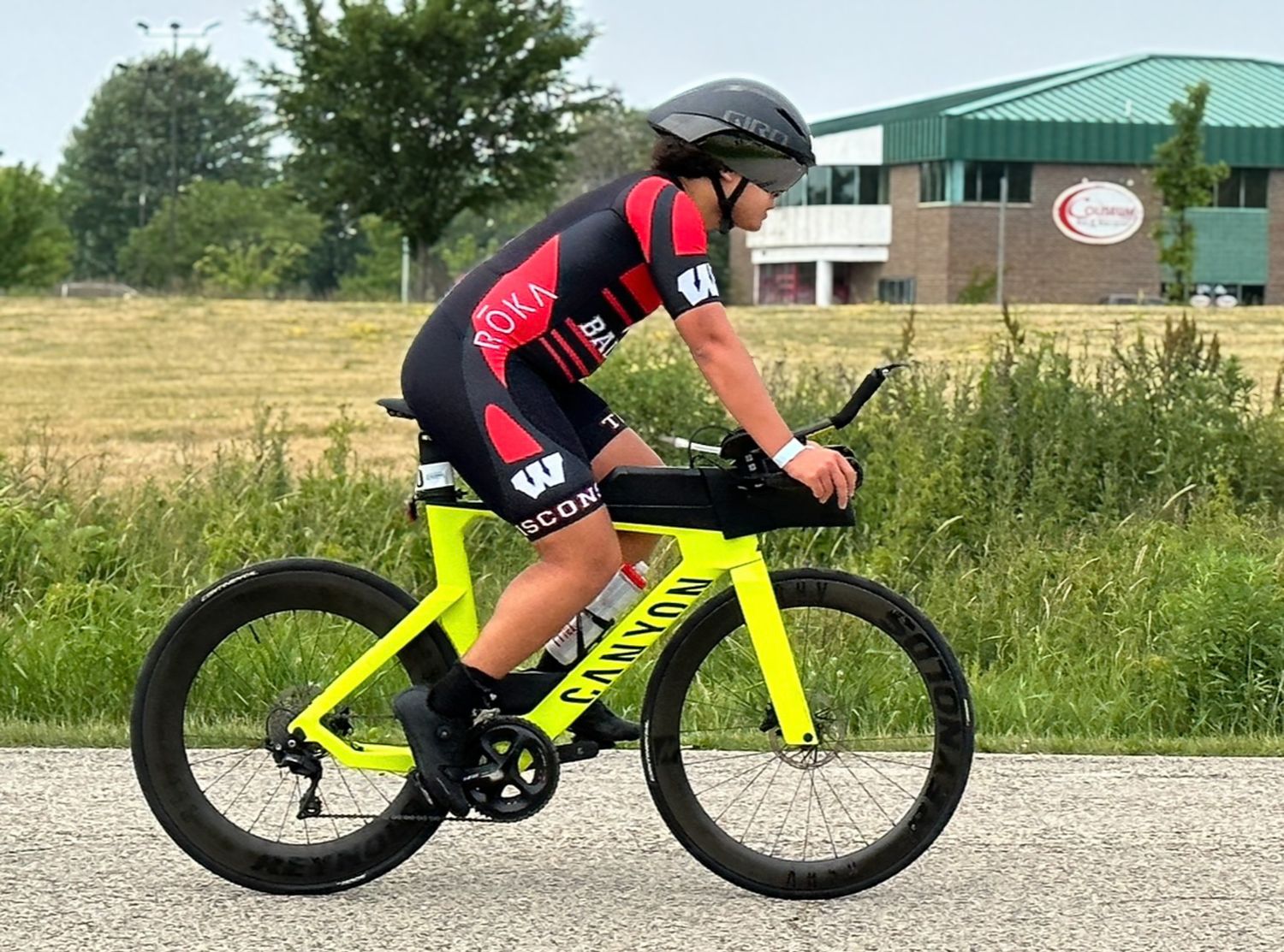 Male triathlete on a neon yellow bike