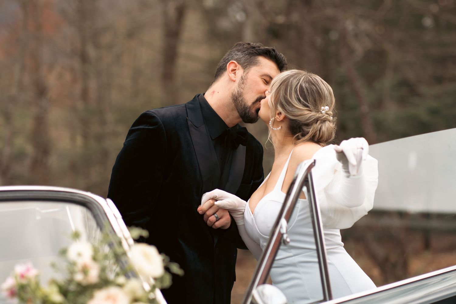 A tender romantic moment captured between a couple in winter attire.
