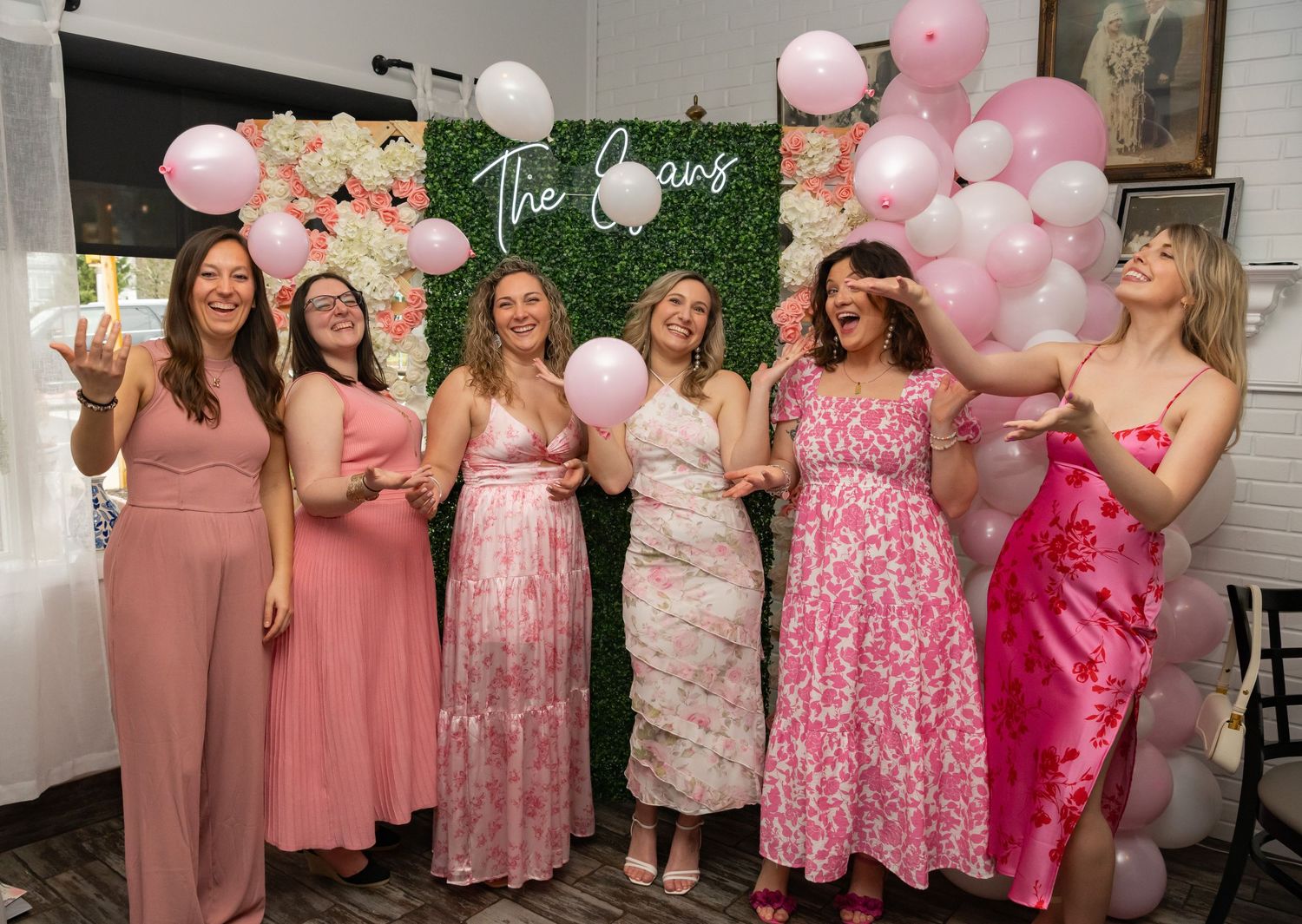 Danielle's bridal shower in front of the step and repeat built by the bridesmaids.