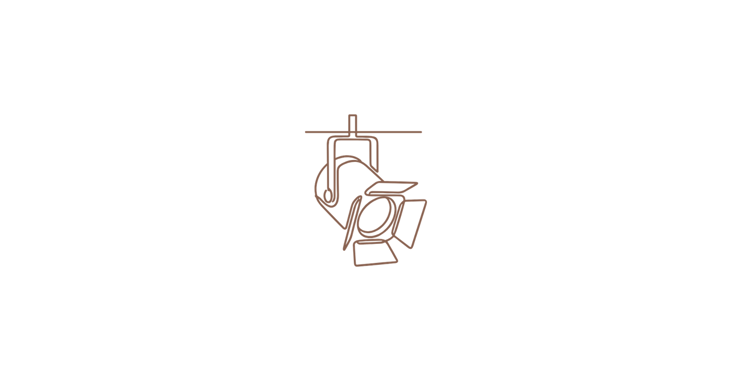 Line drawing icon of a studio spotlight fixture mounted on a track, depicted in a minimalist copper tone style.