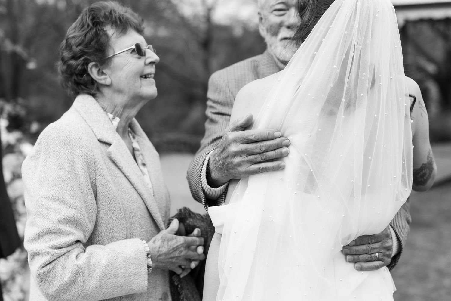 A series of black and white wedding photographs showing tender moments between a bride and groom during their celebration.