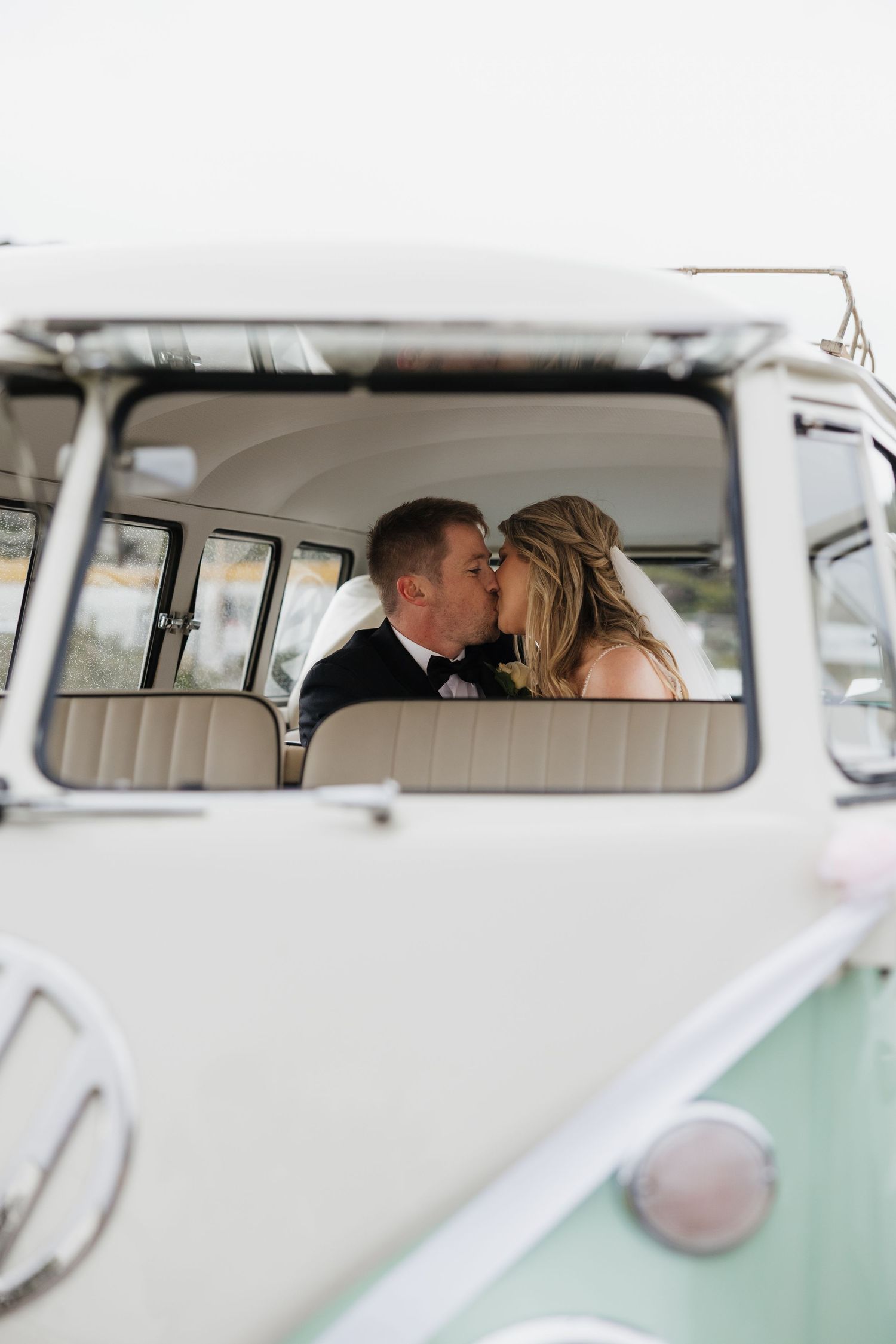 Romantic couple sharing an intimate moment inside a vintage VW van. Wedding at The Baths Sorrento