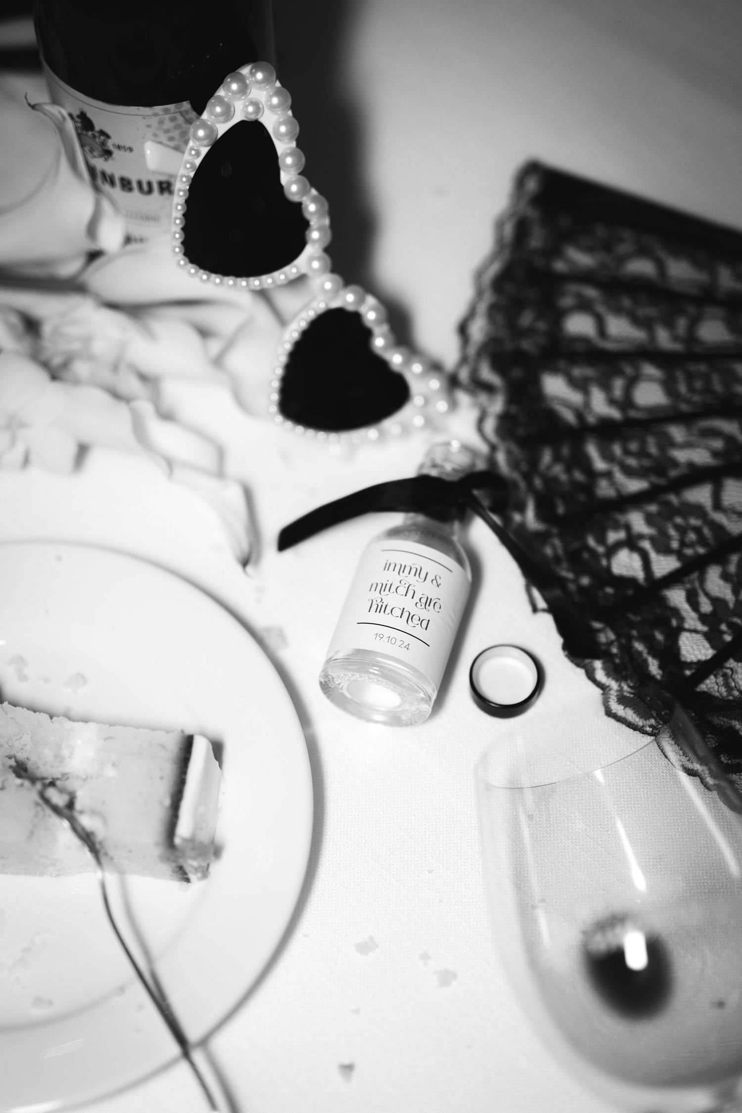 Heart-shaped sunglasses and a ring displayed with romantic wedding details in black and white.