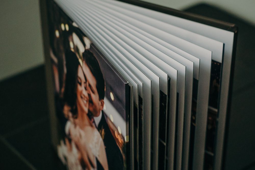 Pages of a wedding photo album fanned out showing memories.