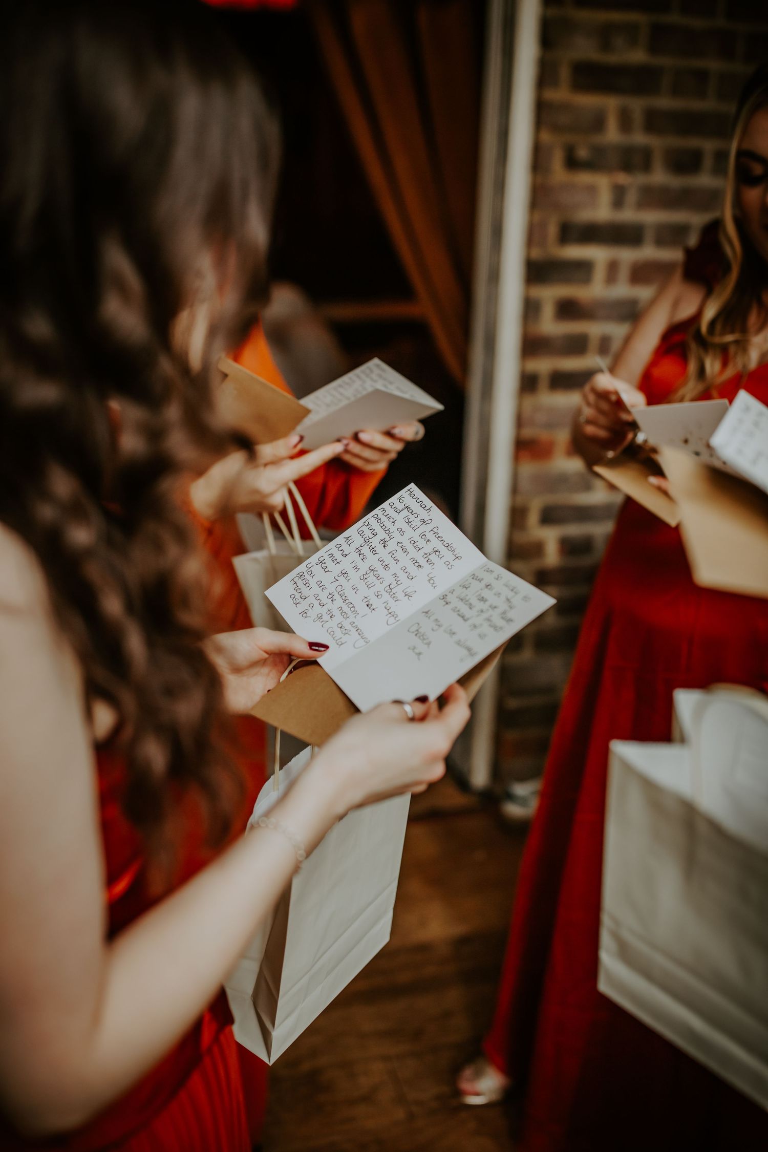 Bridesmaids opening their gifts from the bride on wedding morning.