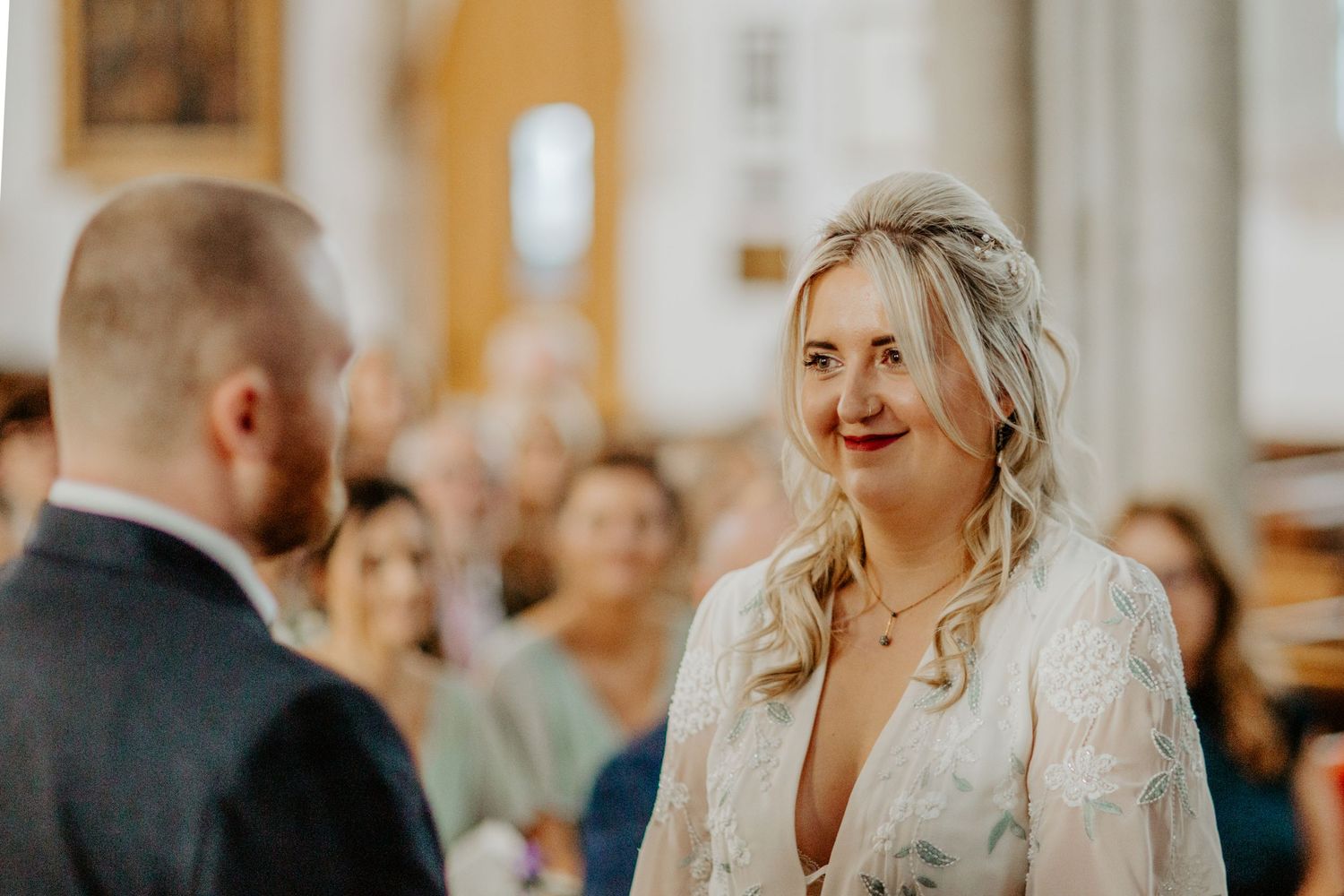 Bride looking at her groom during wedding ceremony at Braughing Church Hertfordshire, Photographer RELM Photography