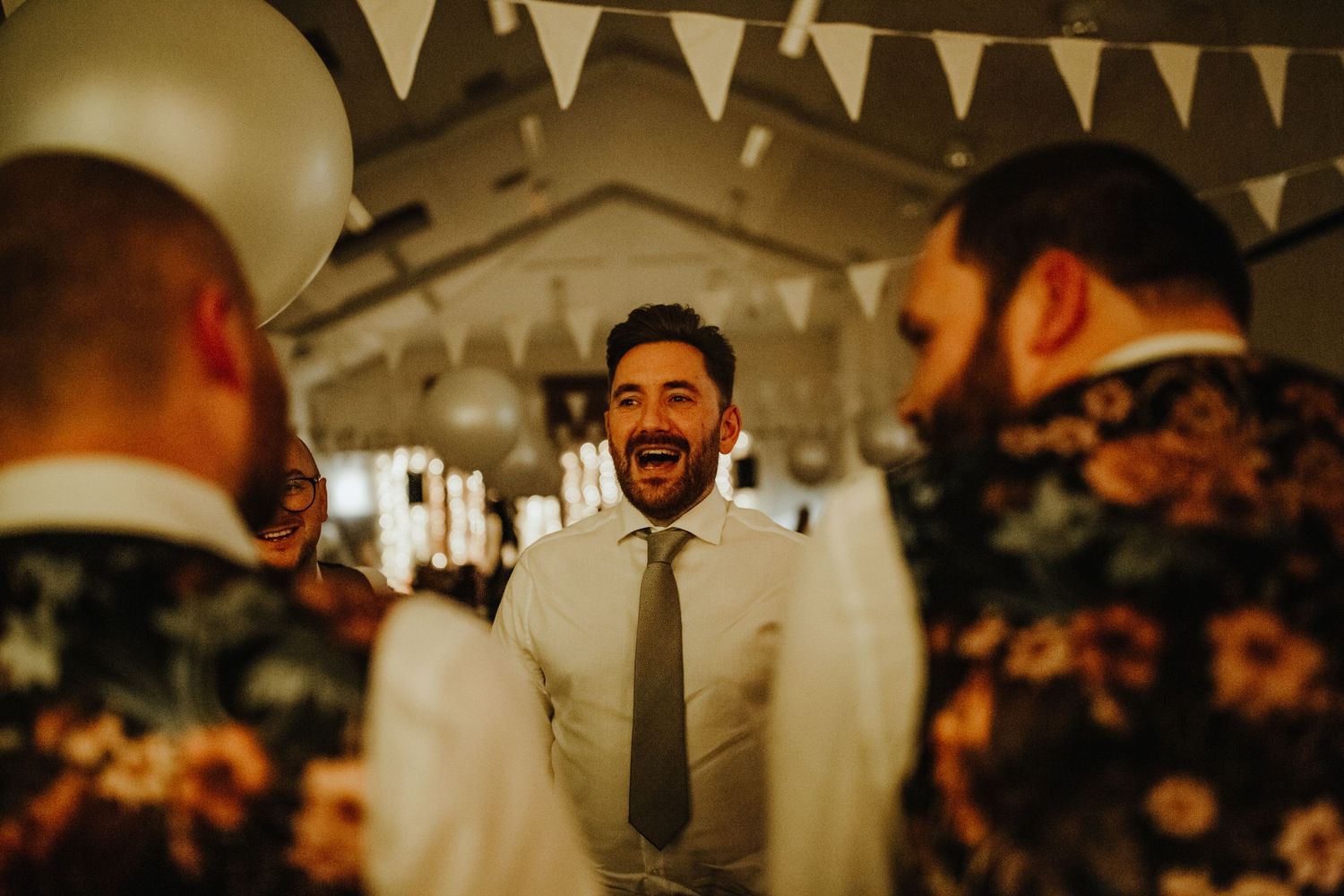 Guest banter at wedding reception at Cottered Village Hall Hertfordshire, Photographer RELM Photography