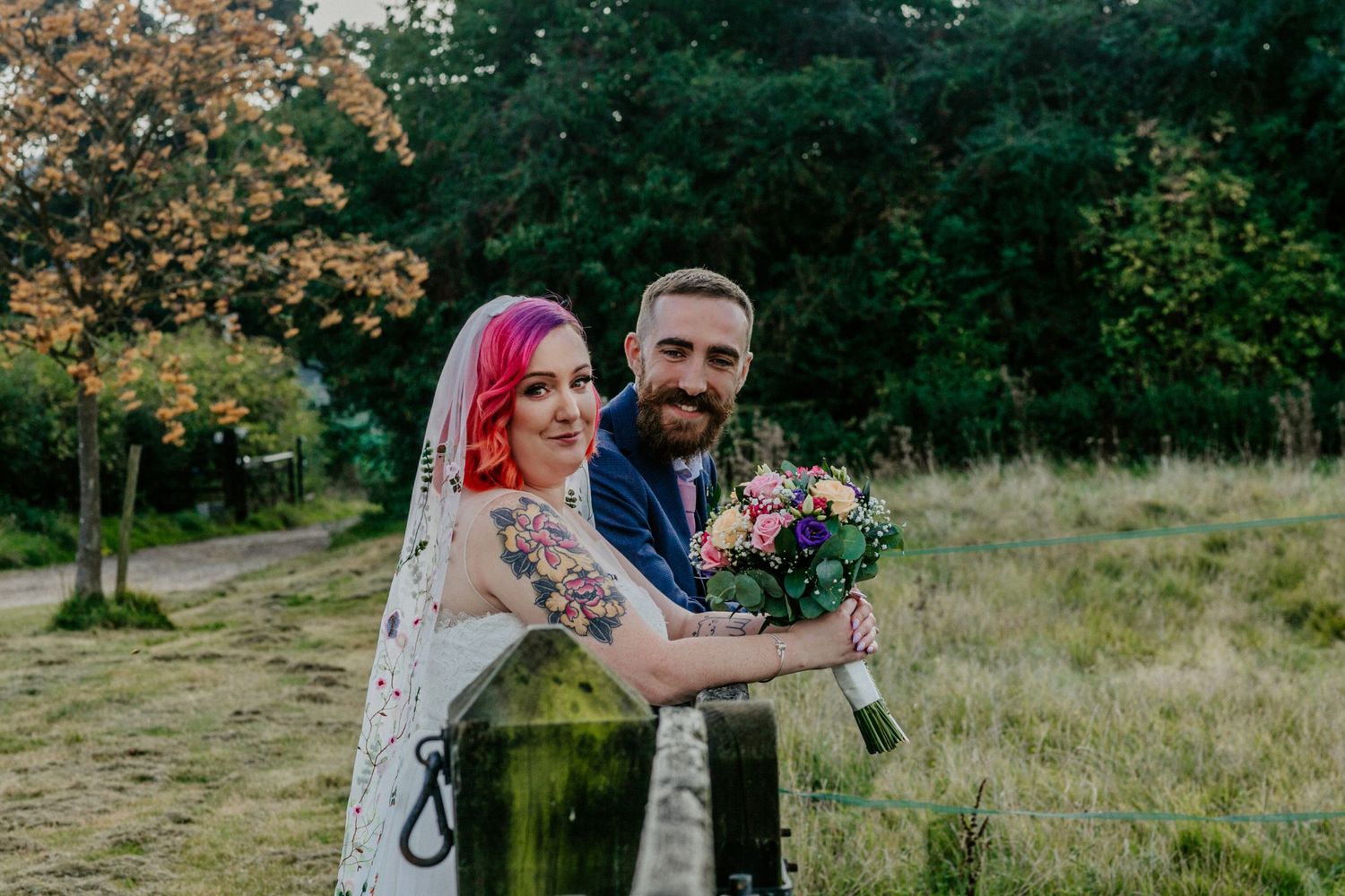 The bride and groom share a quiet moment in the fields of Lodge Farm House, Hertfordshire