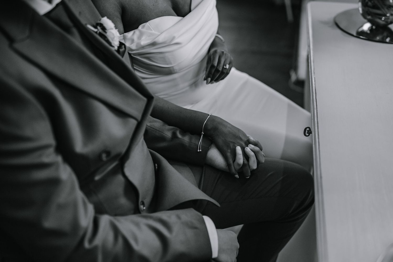 Bride and Groom holding hands under the table at their wedding ceremony at Morden Park House - London - RELM Photography