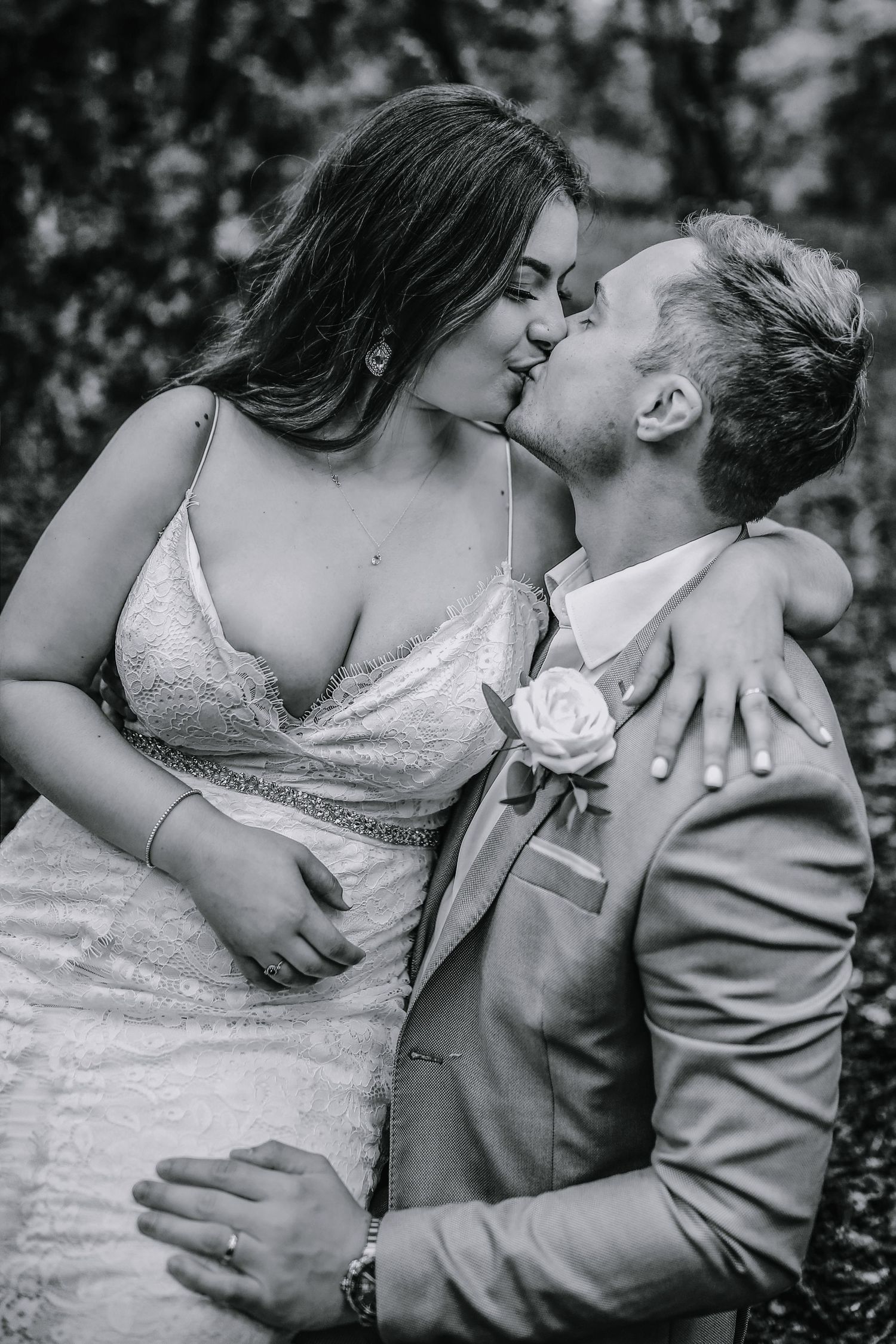 Bride and groom kissing in the woods of Harpenden, Hertfordshire - Black and white wedding photography - RELM Photography