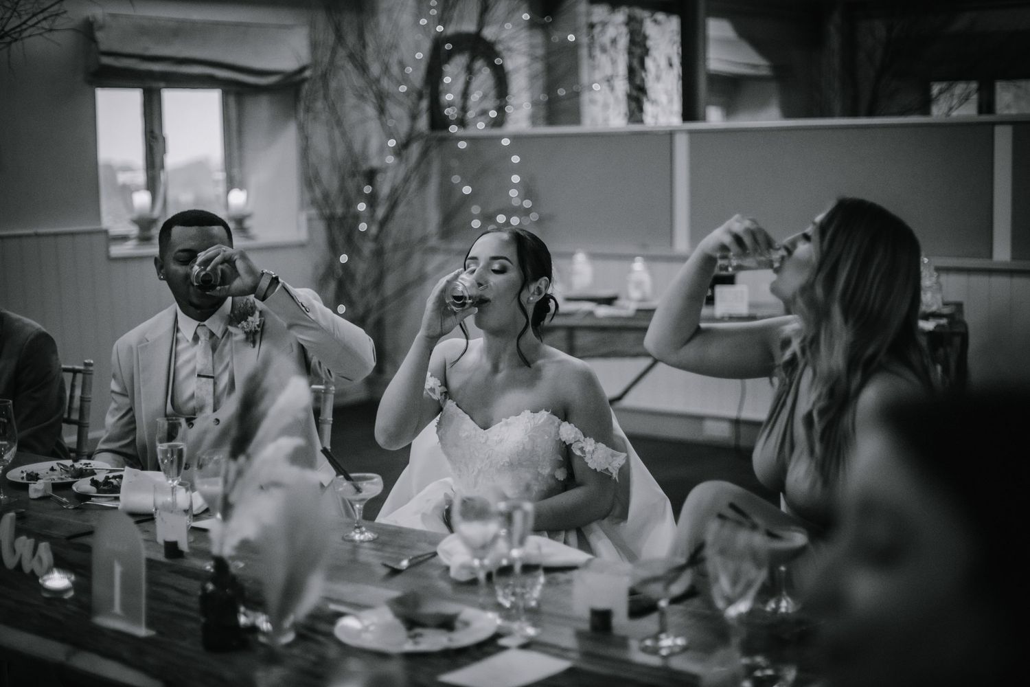 Bride and groom taking shots at their wedding reception at Lapstone Barn – Chipping Campden, The Cotswolds