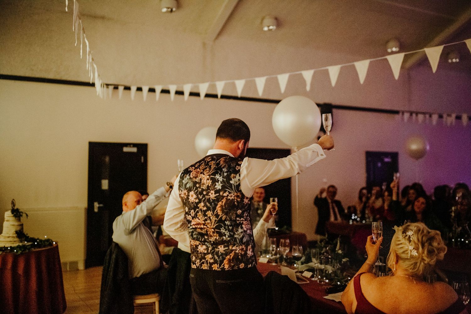 Best man raising a toast at wedding reception at Cottered Village Hall Hertfordshire, Photographer RELM Photography