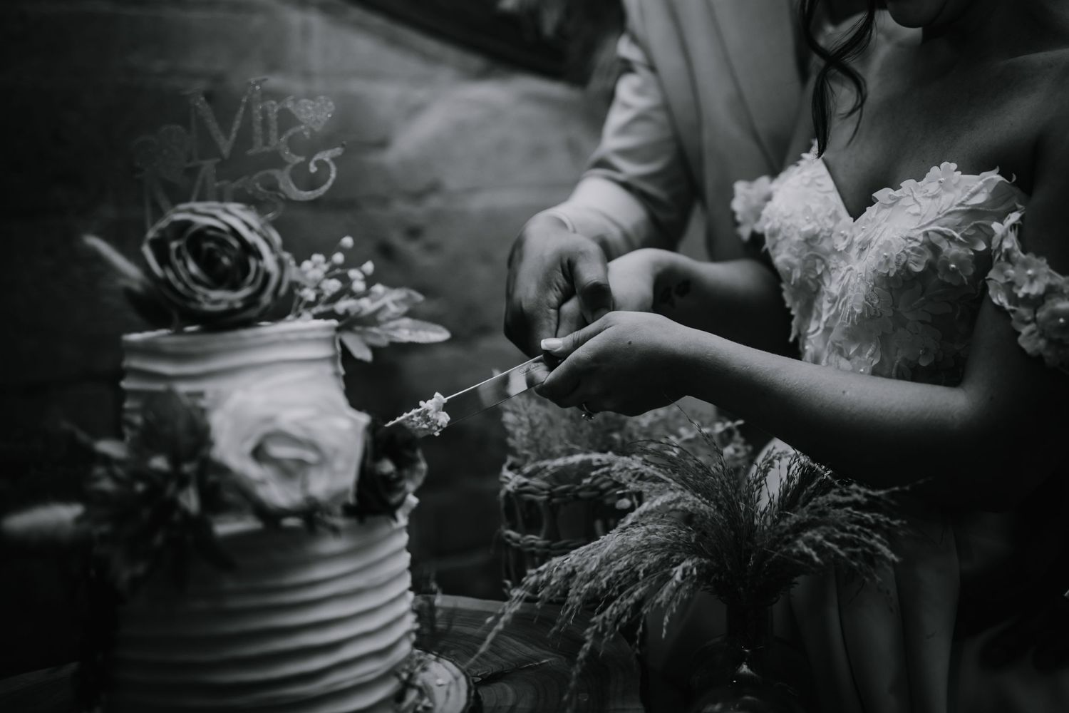 Bride and groom cutting their wedding cake at their wedding venue Lapstone Barn – Chipping Campden, The Cotswolds