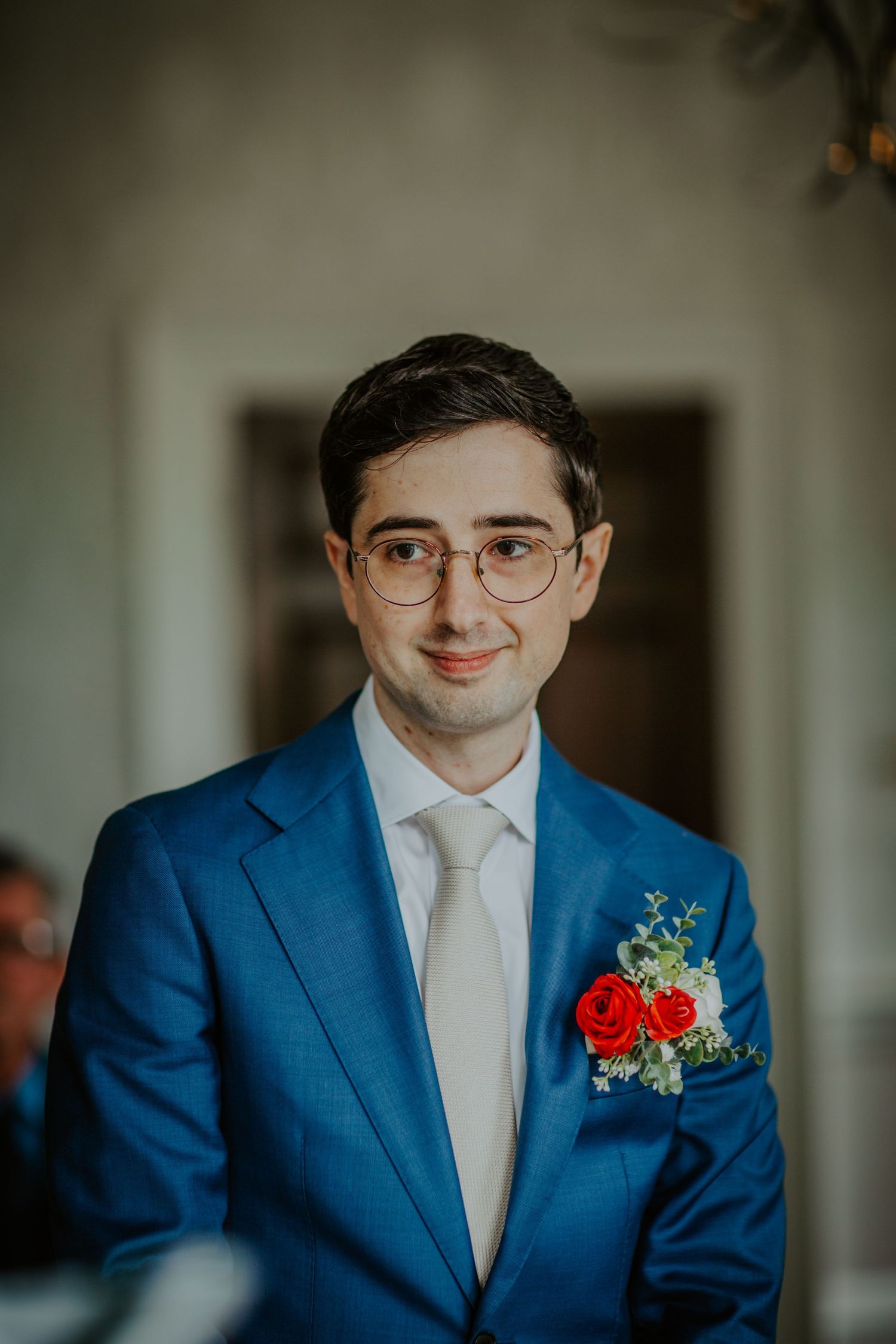 Groom smiles as his bride reads vows in the ceremony at Morden Park.