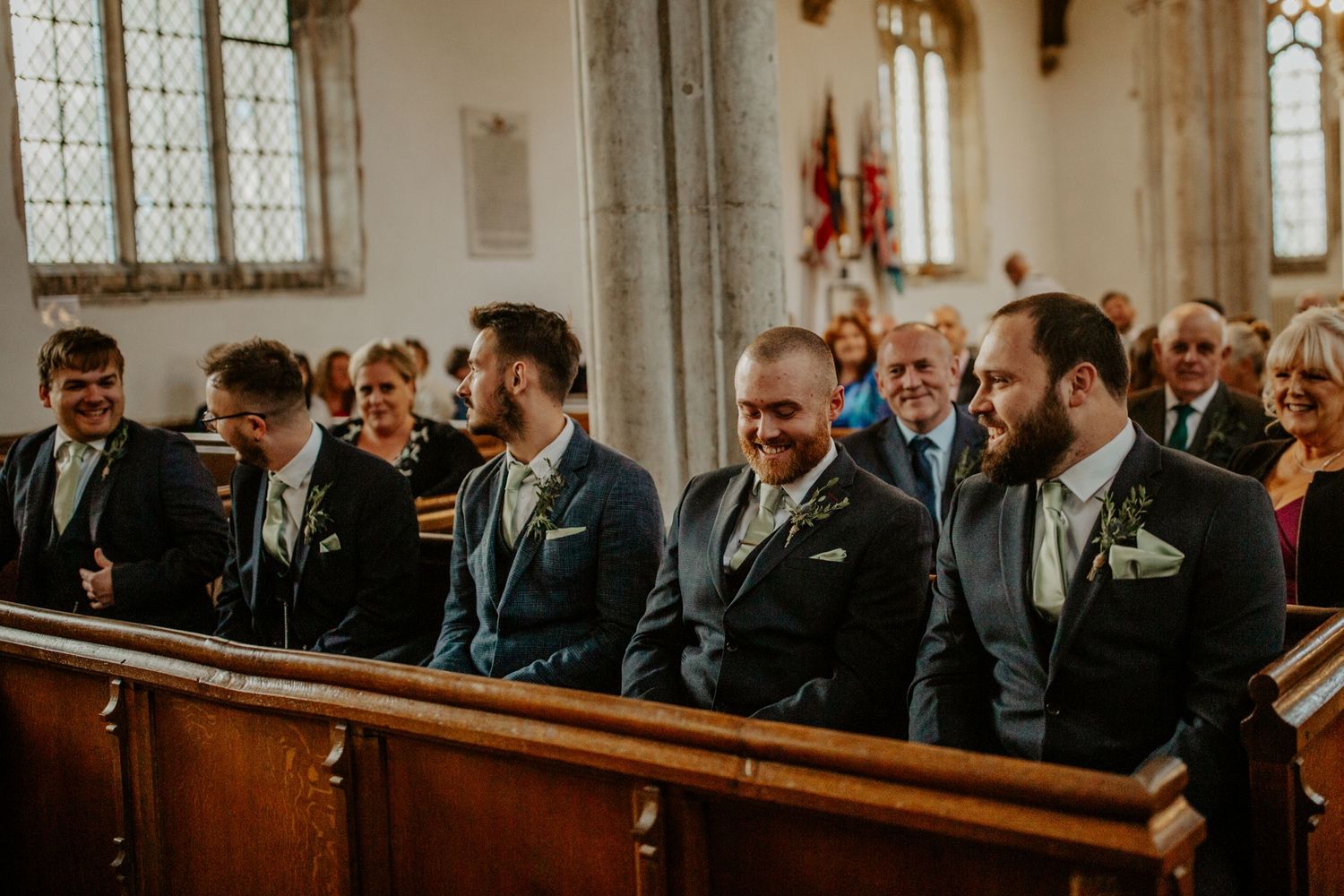Groom with groomsmen and ushers excited at Braughing Church, Hertfordshire – RELM Photography.