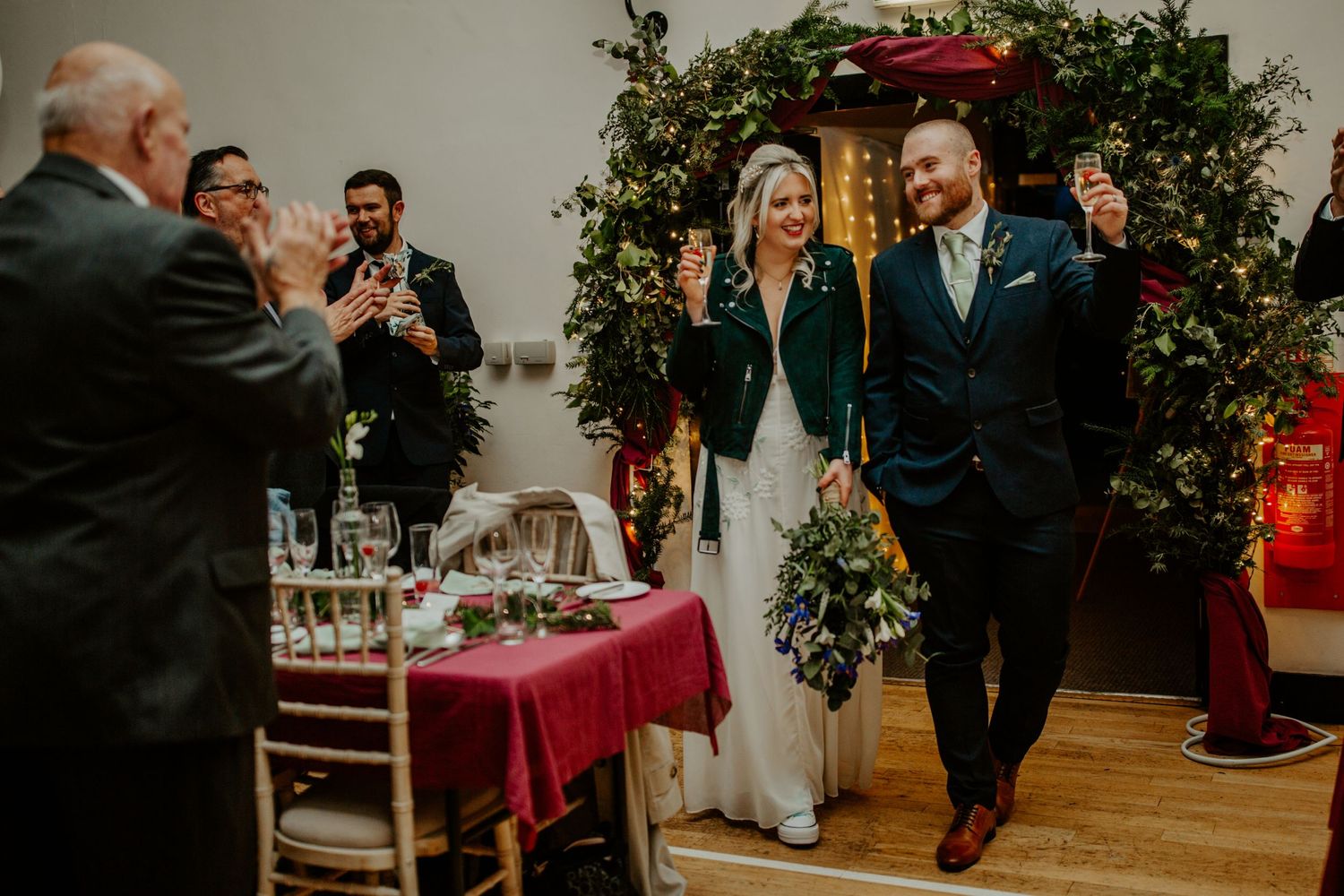 Bride and Groom entering their wedding reception at Cottered Village Hall Hertfordshire, Photographer RELM Photography
