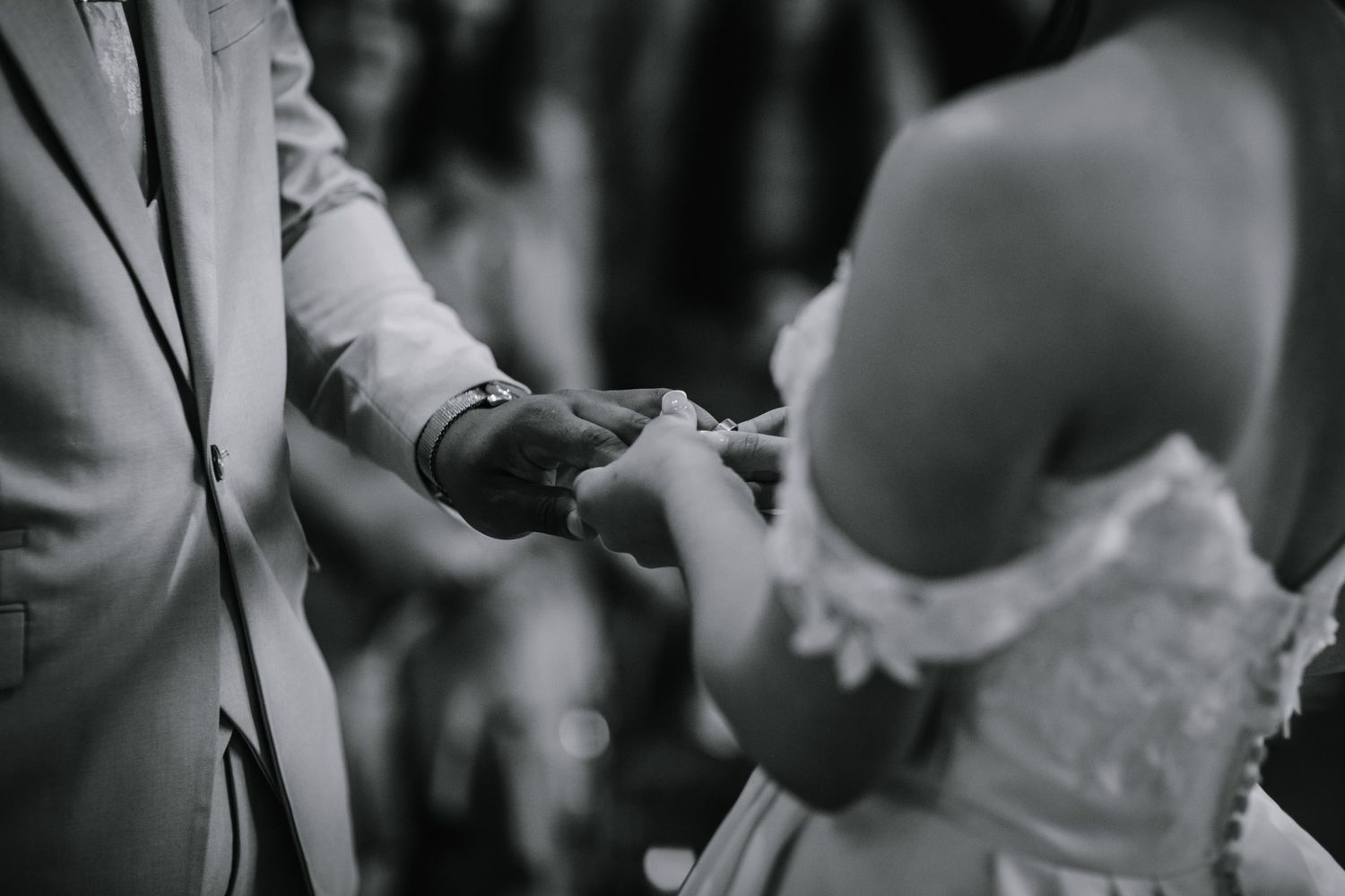 Bride and groom exchanging wedding rings at their wedding ceremony - Lapstone Barn – Chipping Campden, The Cotswolds