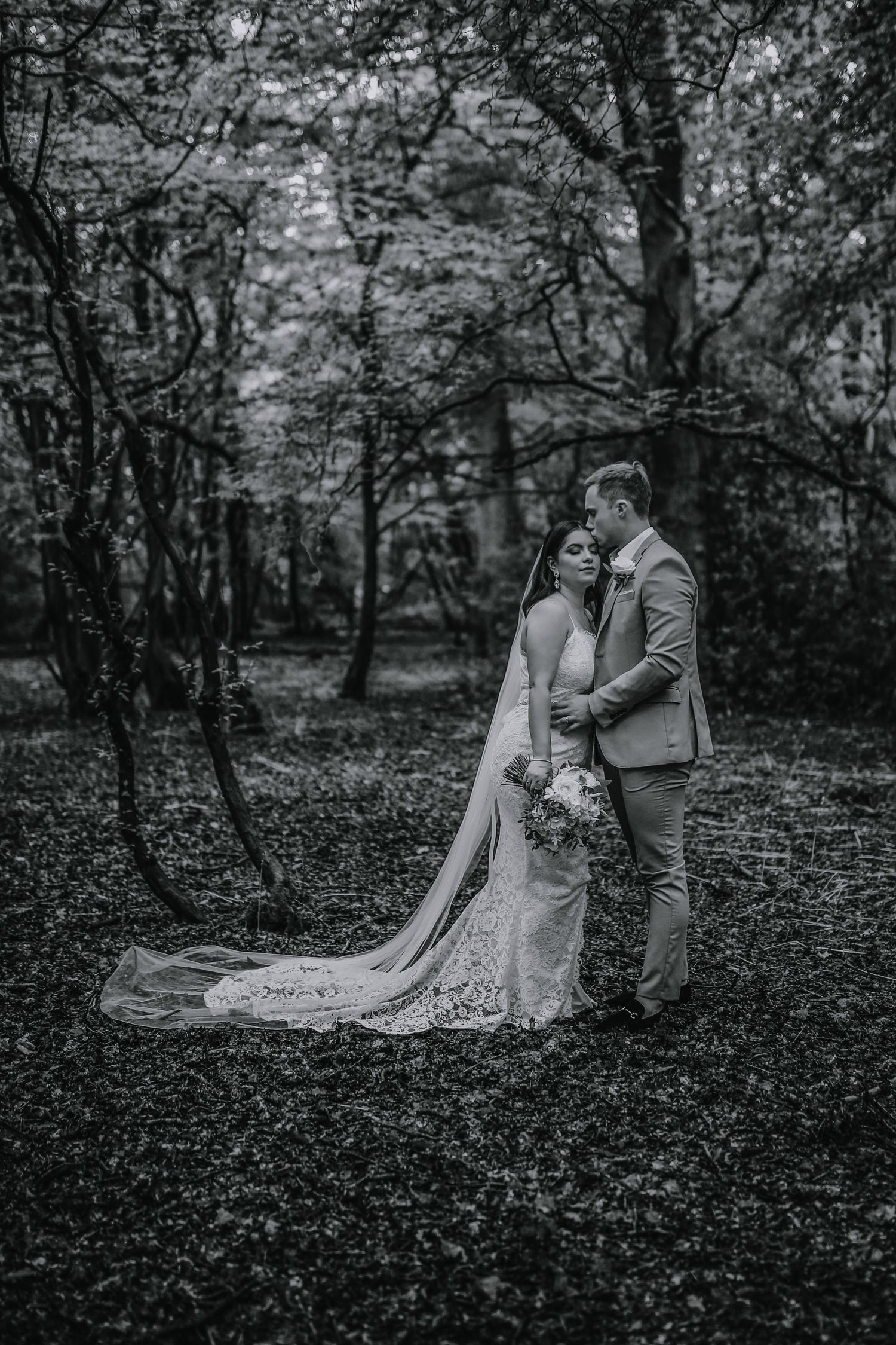 Bride and groom posing in the woods of Harpenden, Hertfordshire - RELM Photography