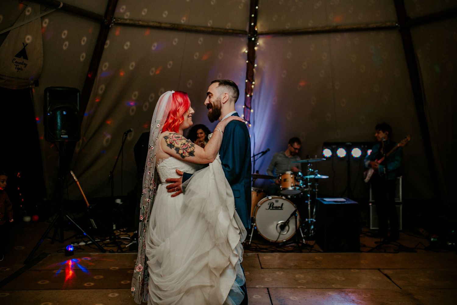 Eyes only for each other – The couple share a loving gaze as they sway on the dance floor, wrapped up in the moment.