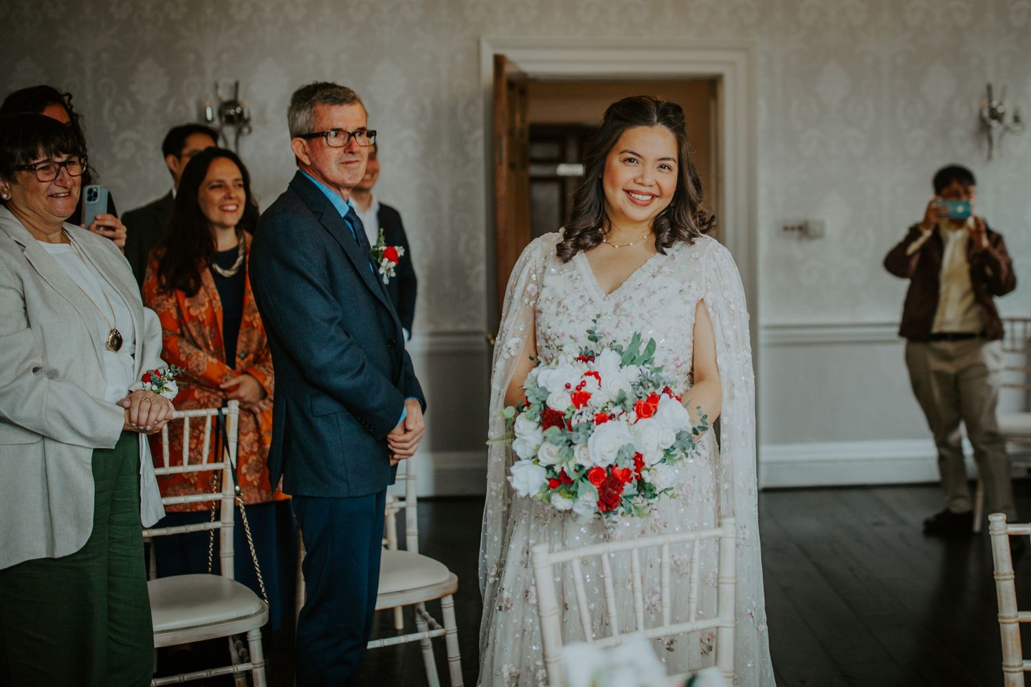Bride walks down the aisle towards her groom during a romantic wedding ceremony.